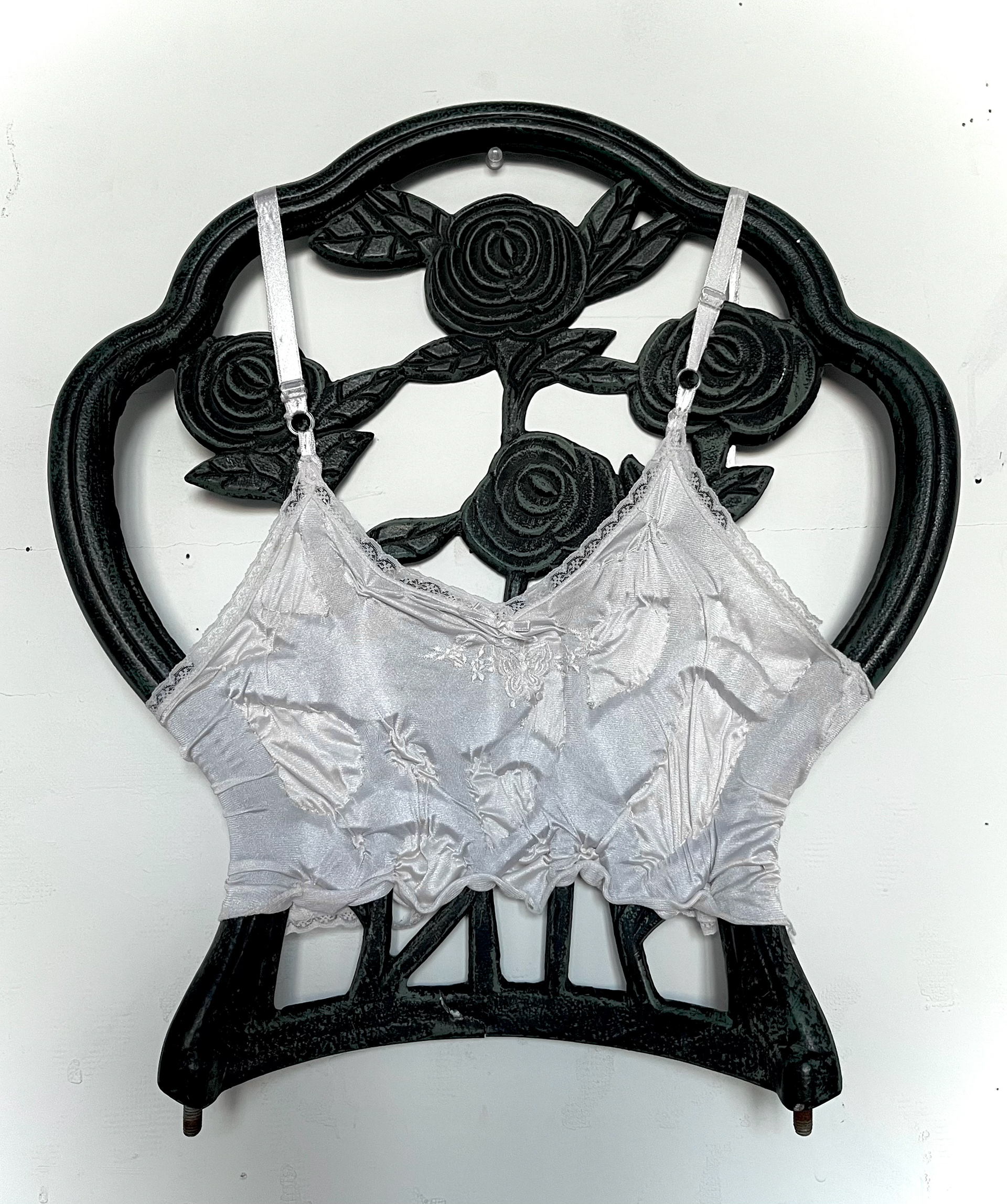 "Wearing White" (found metal gate, camisole, thread)