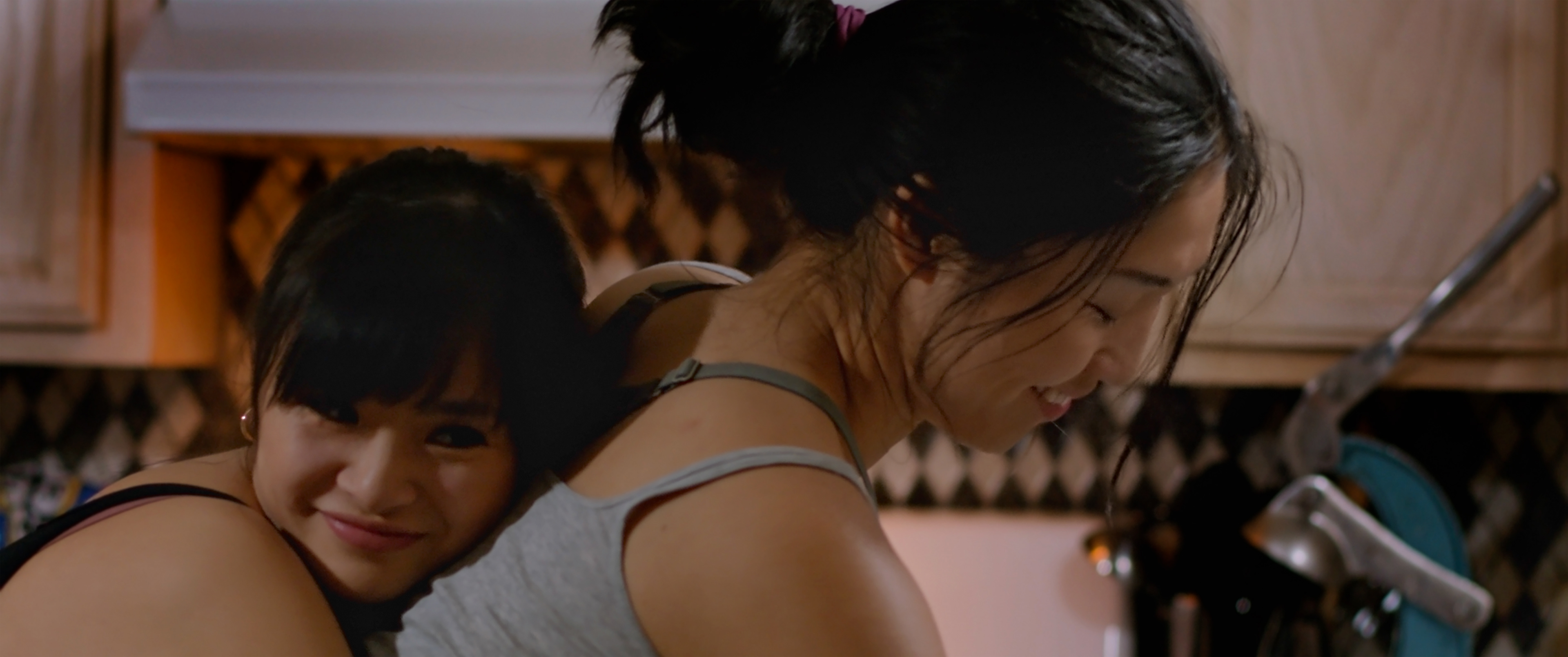 Tera (Hedy Wong) hugs Mom (Lynna Yee)