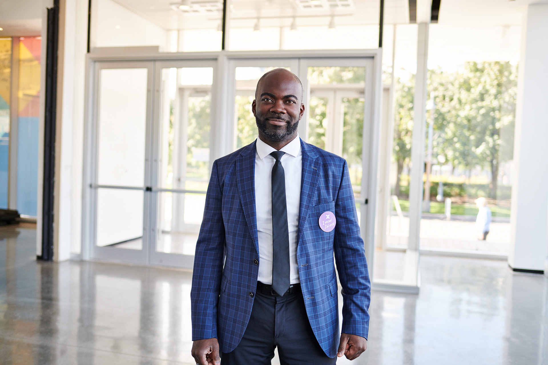 a black successful businessman stand for an editorial style portrait