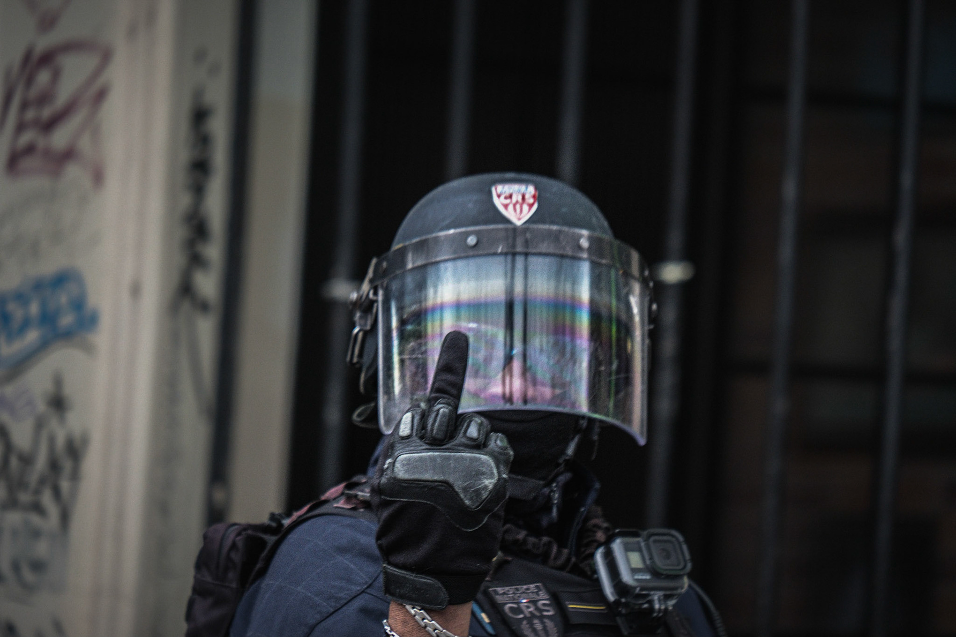 A policeman is showing a middle-finger to the photographer in reaction to him taking a photography. Demonstration against the Global Security law and for the defense of Free Parties, on the Place de la Republique. Paris, France 2021/01/30. Photography by Maxime Gruss / Hans Lucas. Un CRS fait un doigt d'honneur au Photographe, auteur de la photo,en réaction a la prise de vue. Manifestation contre la loi de securite globale et pour la defense des Free Party du Samedi 30 Janvier Place de la Republique. Paris, France, 2021/01/30. Photographie par Maxime Gruss / Hans Lucas.