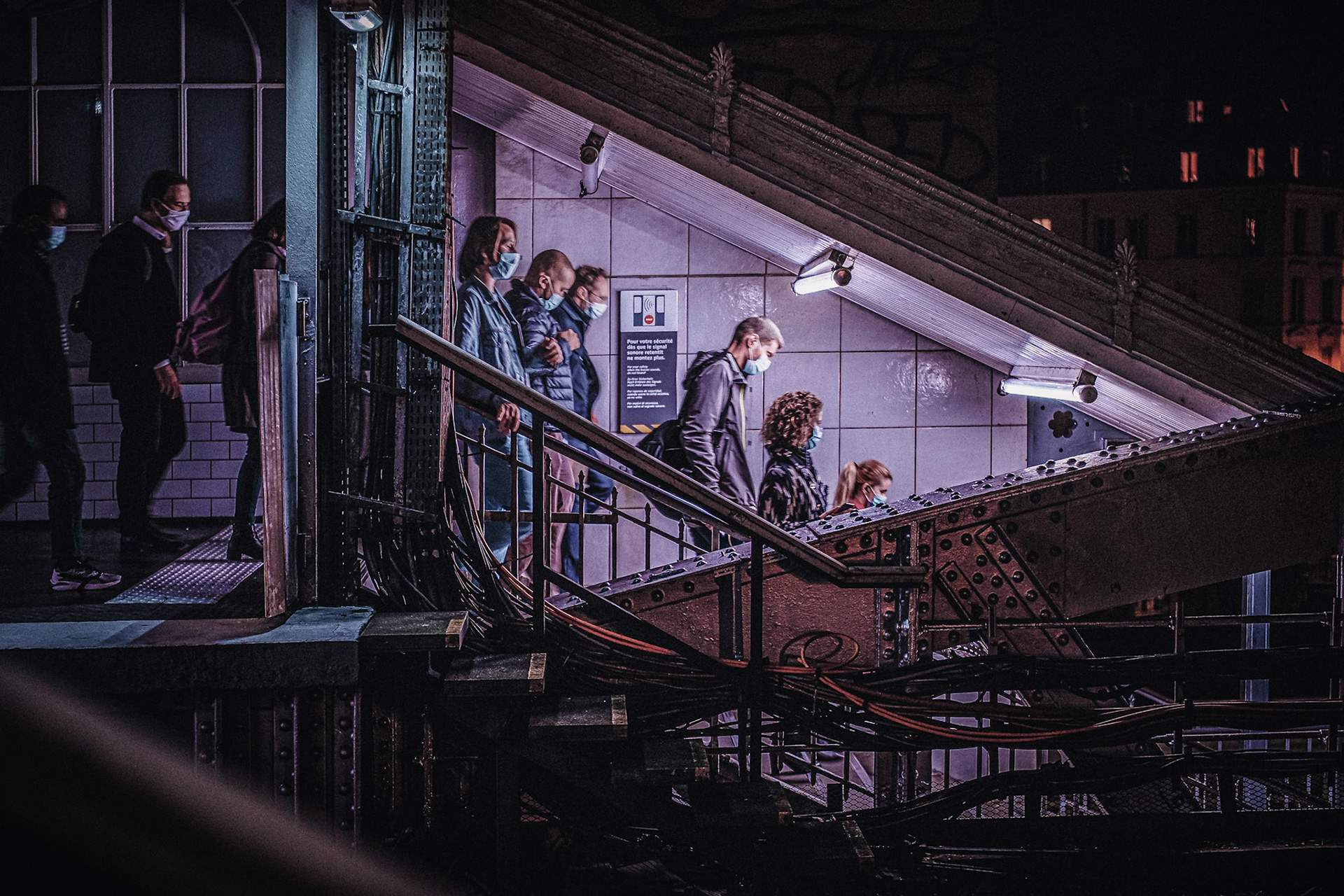 People in a metro station under curfew