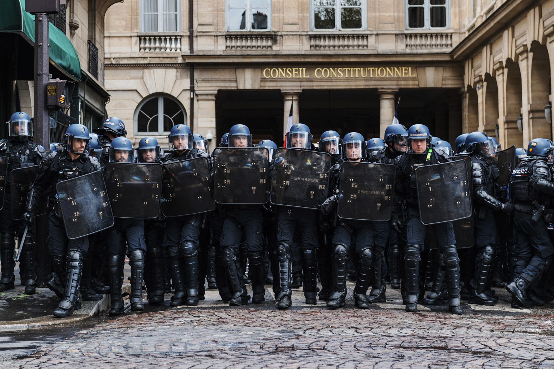 Policemen guard the constitutional council. Protesters take part in a demonstration on the 12th day of action after the government pushed a pensions reform through parliament without a vote, using the article 49.3 of the constitution, in Paris, on April 13, 2023. France faced nationwide protests and strikes on April 13, 2023, to denounce the French government's pension reform on the eve of a ruling from France's Constitutional Council on the reform.