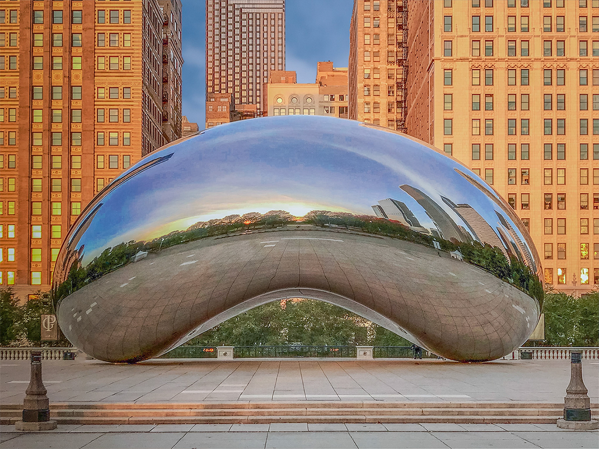 Sunrise captured in a reflection on "The Bean"