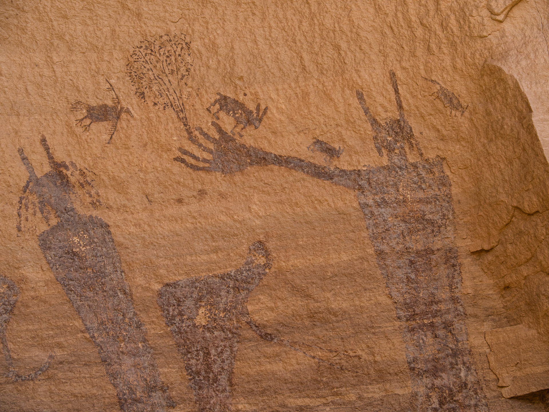 Friendly animals and a figure with a tree growing out of its finger