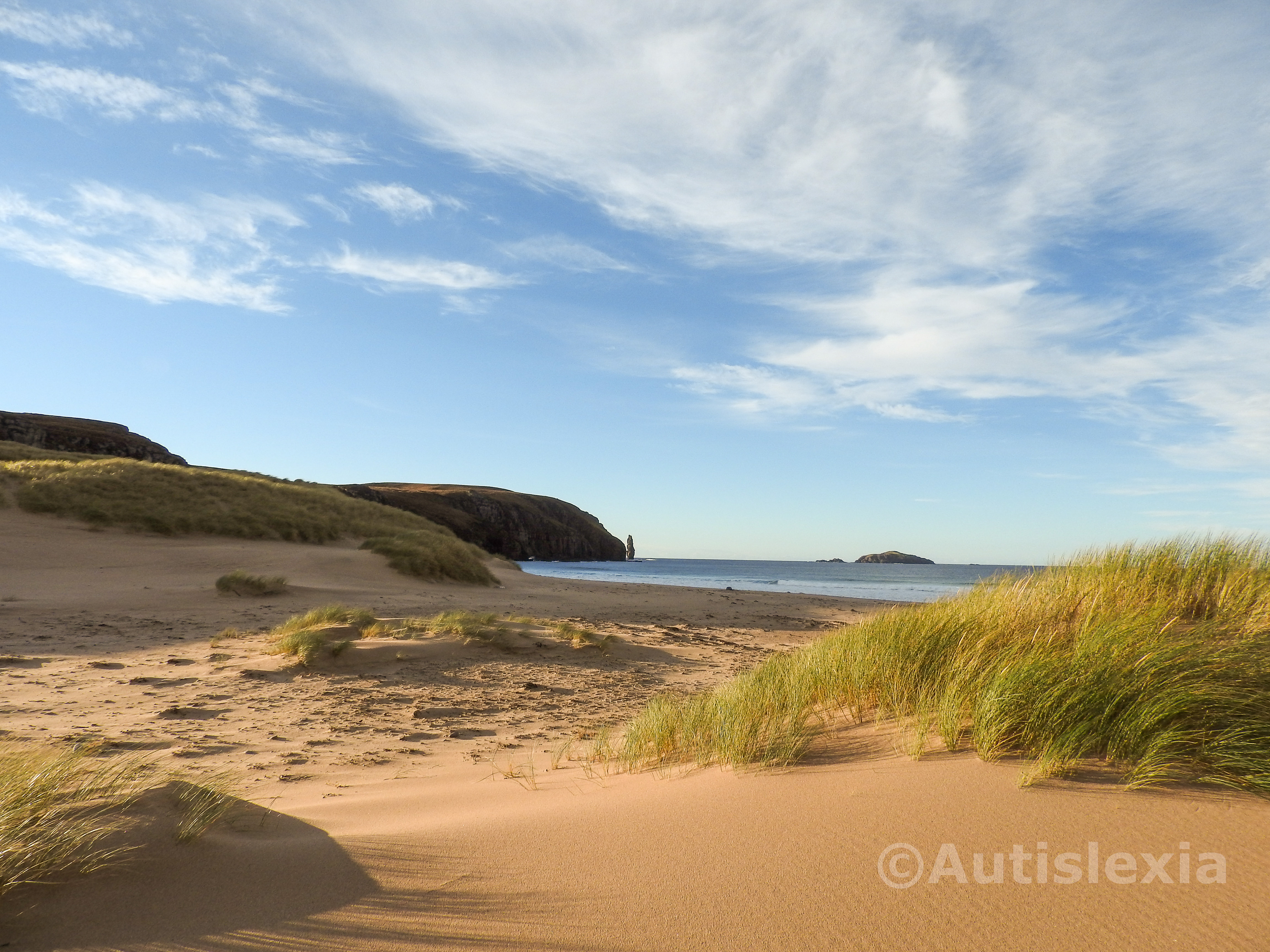 Image of Sandwood Bay from the sand dunes looking towards the stack at the end of the cliffs.