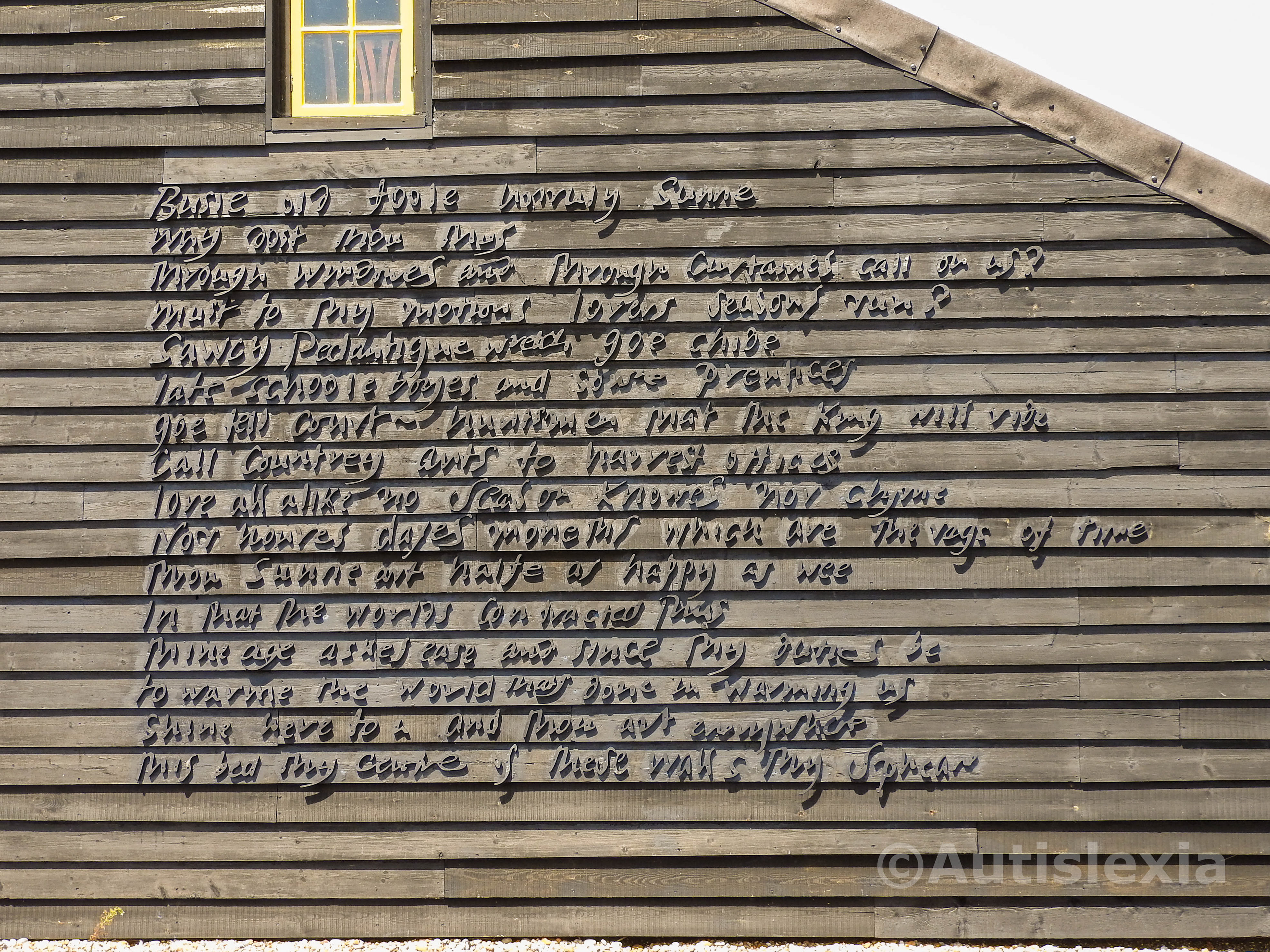 Writing on the side of Prospect Cottage.; a John Donne poem called "The Sun Rising"