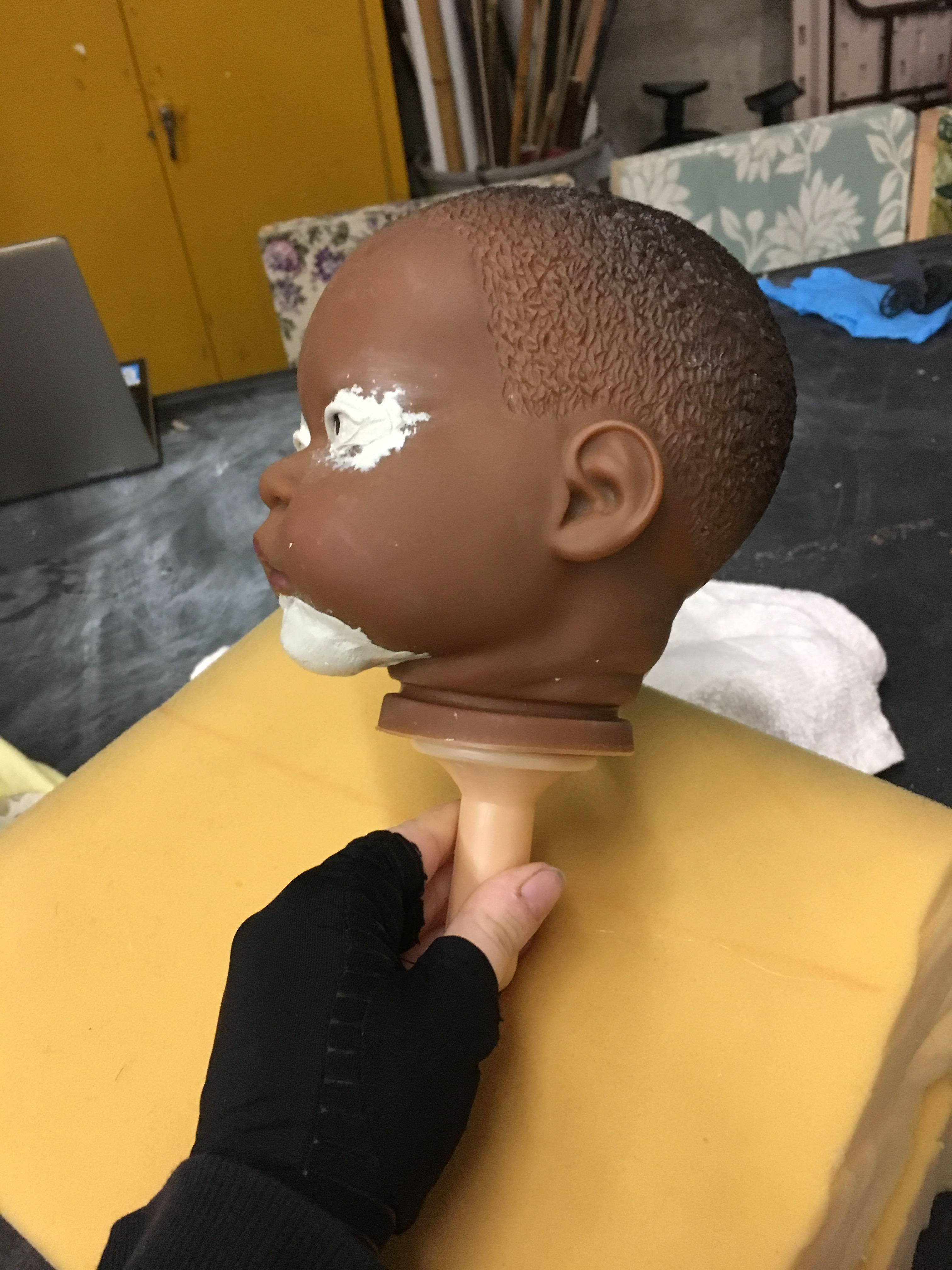 Re-Sculpting face of pre existing baby doll toy.