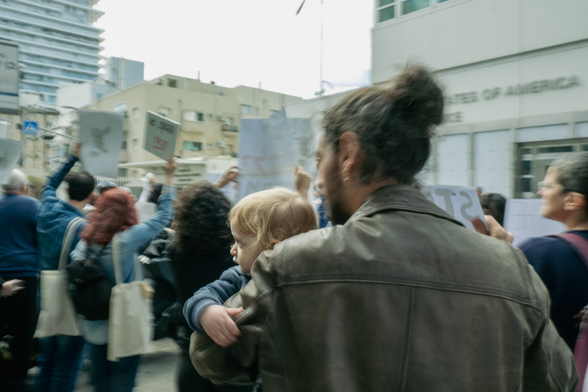 Father holding his kid during a protest for Ceasefire in Gaza in front of US Embassy. Tel Aviv - 8 March 2024