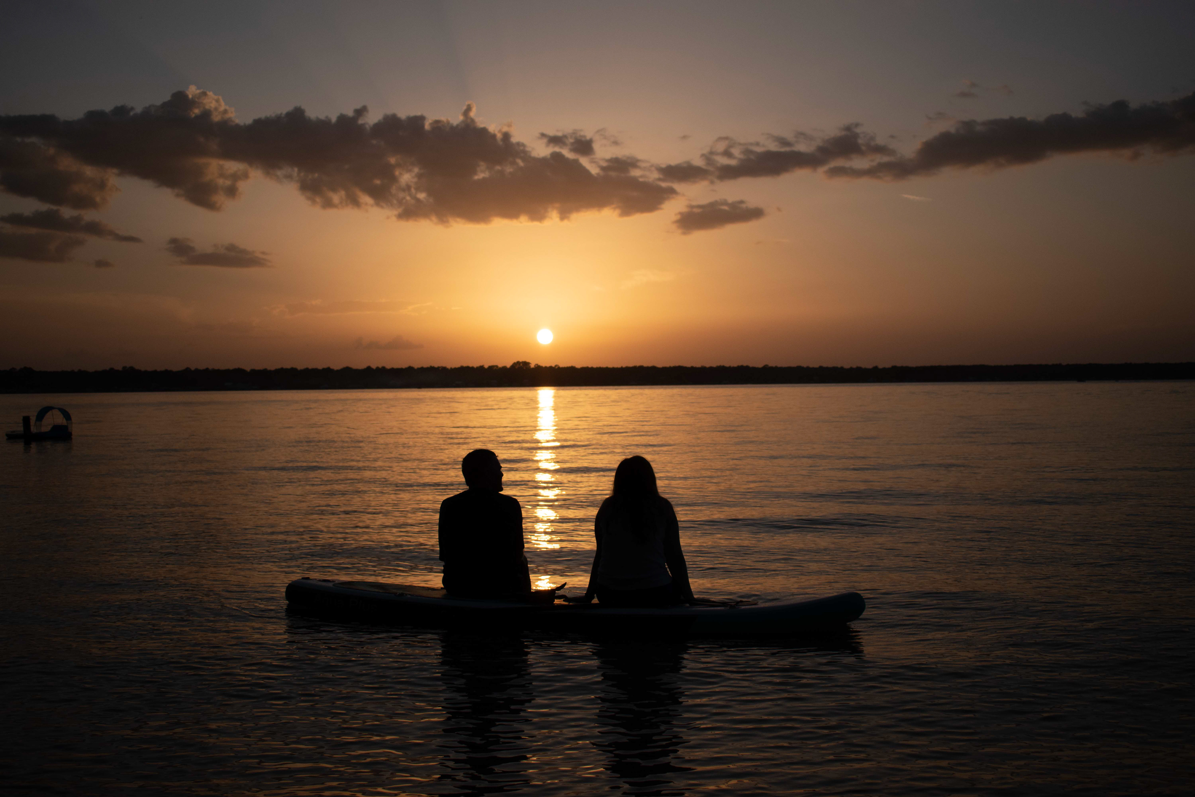 Paddleboarders Watching Sunset