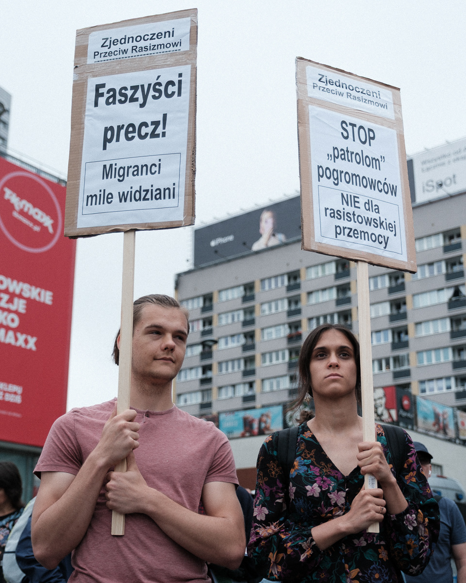 Left: "Fascists out! Refugees welcome!"; Right: "Stop the pogrom 'patrols', no to racist violence''