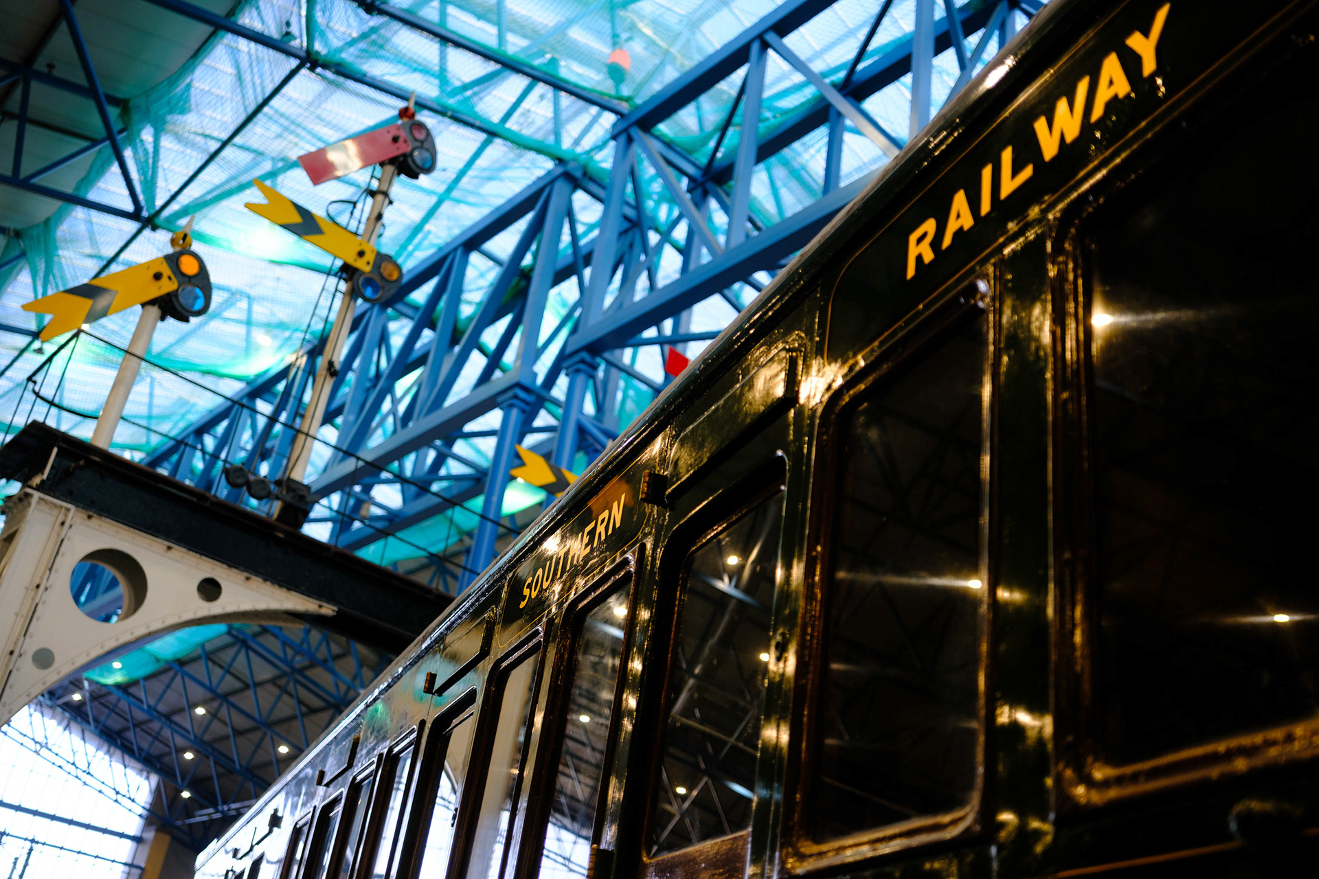 Ref: NRM_20260115_0021. Southern Railway stock and semaphore signal gantry. National Railway Museum, York, North Yorkshire, United Kingdom, 15 January, 2026.
