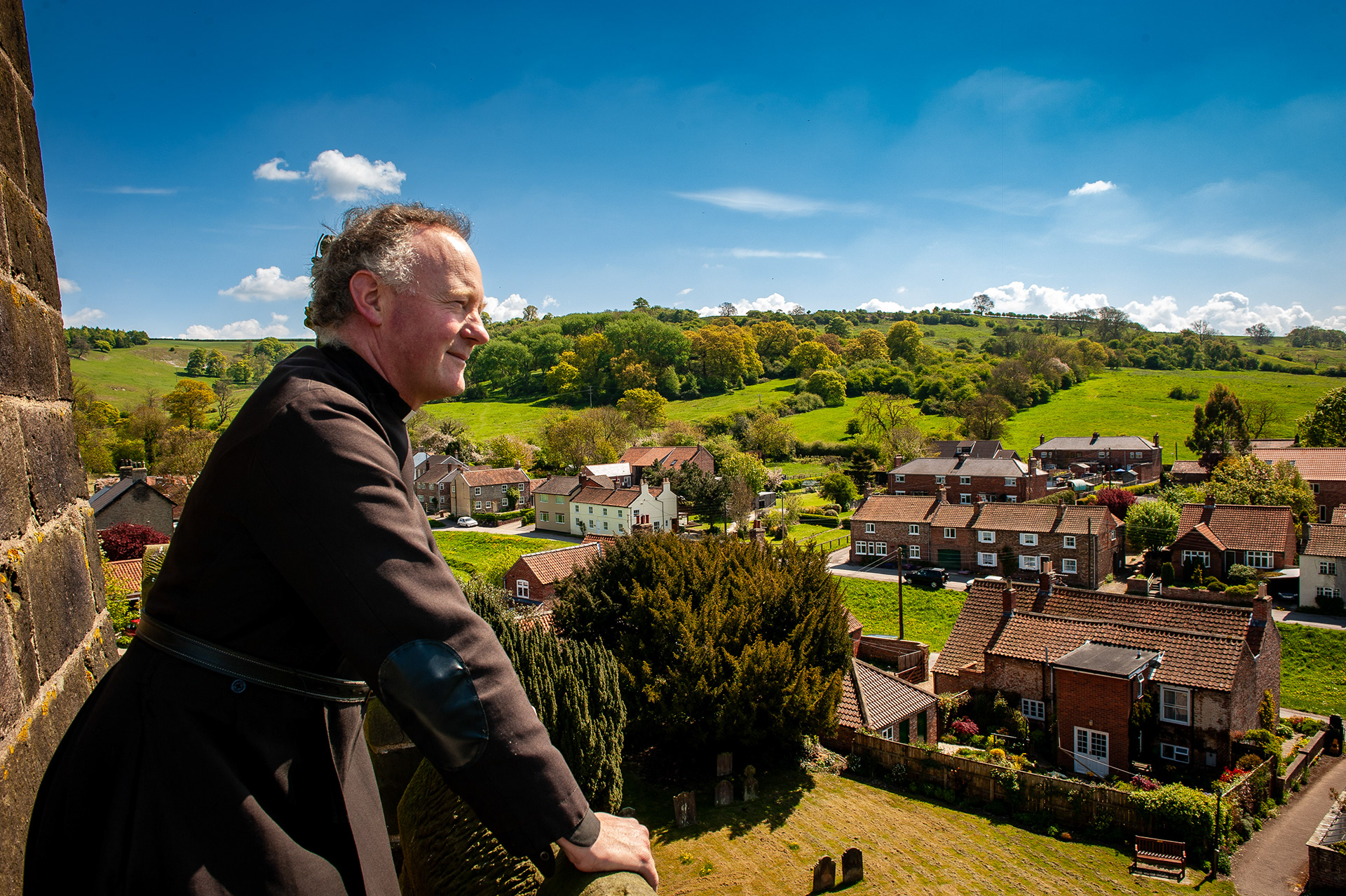Ref: James Finnemere_20100516_1384. Pictured: Father James Finnemere, parish priest, J.S. Edith's. Surveys his parish from the tower of the church. Bishop Wilton, East Yorkshire, United Kingdom, 18 May 2010. 