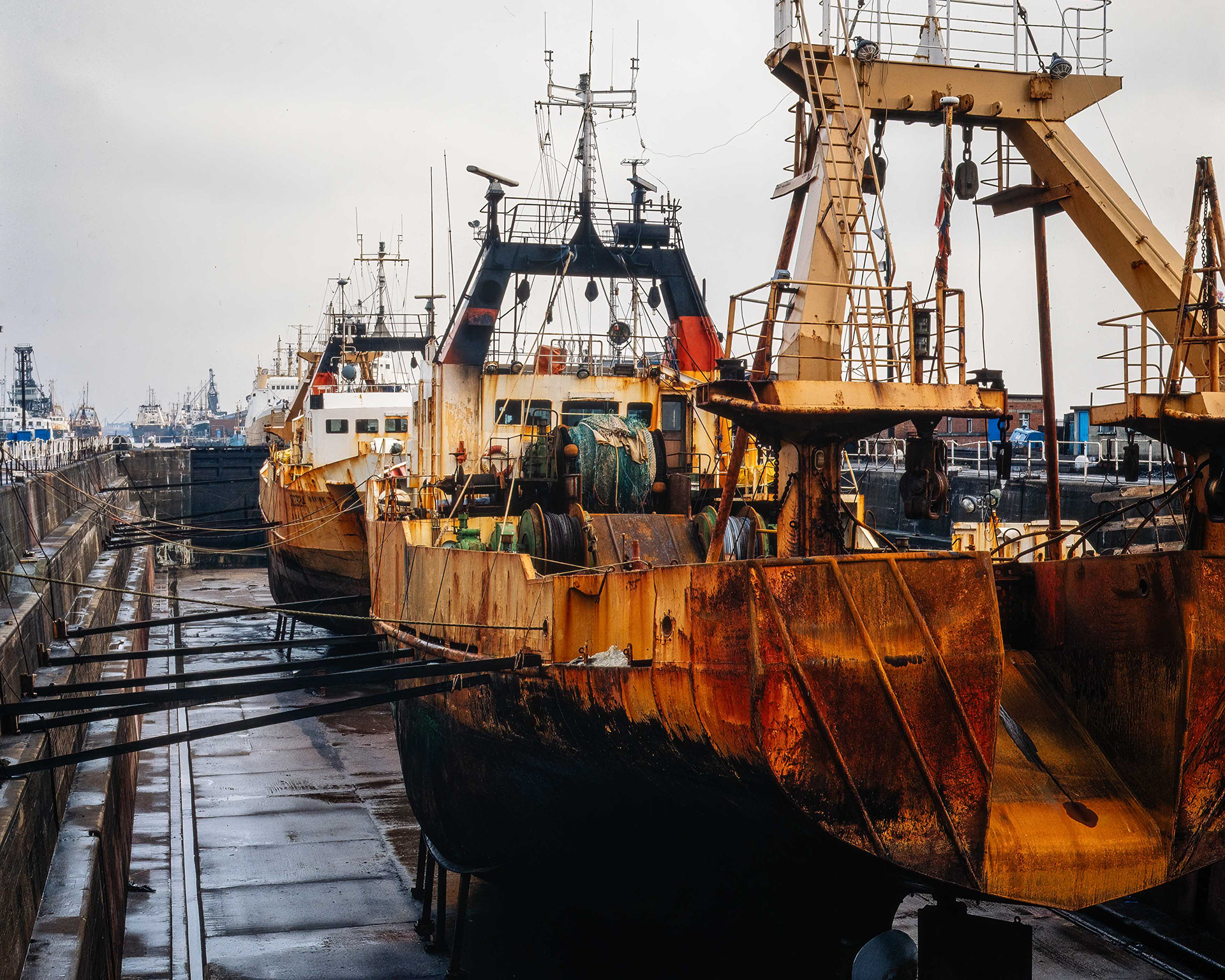 Ref: WW Dock_19840312_0001. Two Fleetwood trawlers seen in dry dock in Hull, the furthest vessel is M.T. Norina (2) - FD324, completed by Goole Shipbuilding & Repair Co Ltd in 1975 (Yd. No. 585) for J Marr & Sons, the sister trawler in the forground M.T. Idena - FD325 Completed in 1976 by Goole Shipbuilding & Repair Co Ltd, Goole (Yd. No. 586) for J Marr & Son Ltd, Fleetwood as IDENA. Registered at Fleetwood. William Wright Dry Dock, Kingston Upon Hull, East Yorkshire, United Kingdom, 12 March, 1984.