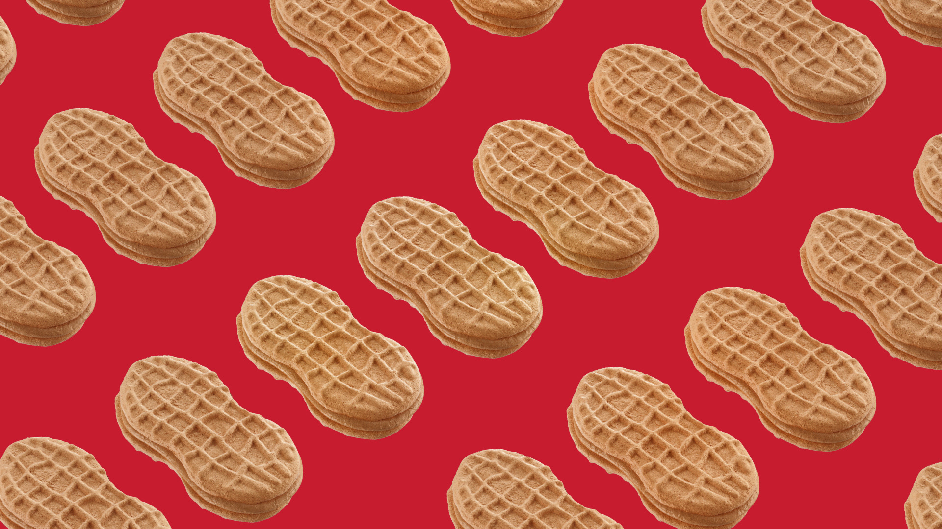 Peanut-shaped cookies arranged in a repeating pattern against a red background.