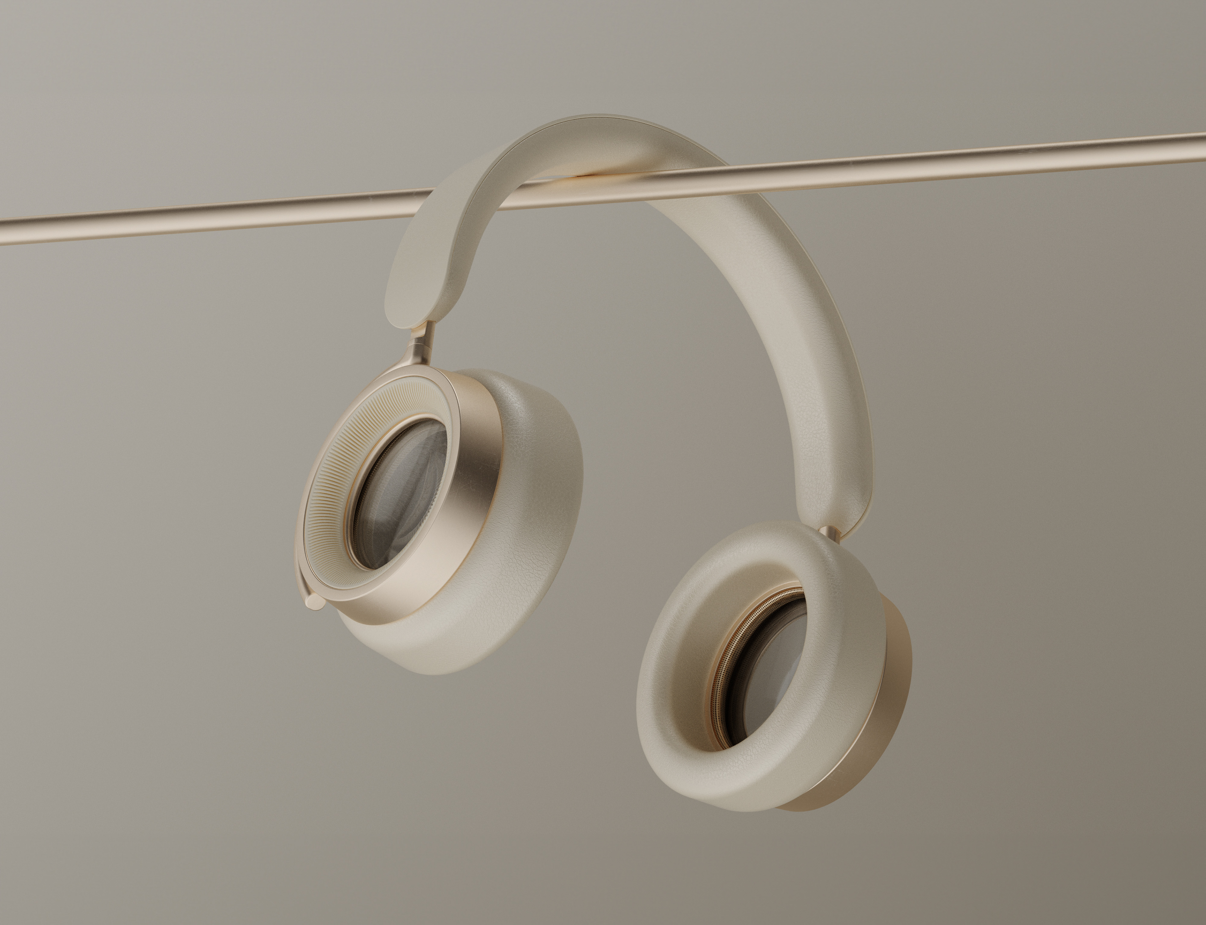 Elegant beige and gold over-ear headphones hanging on a minimalist metallic rod against a neutral background.
