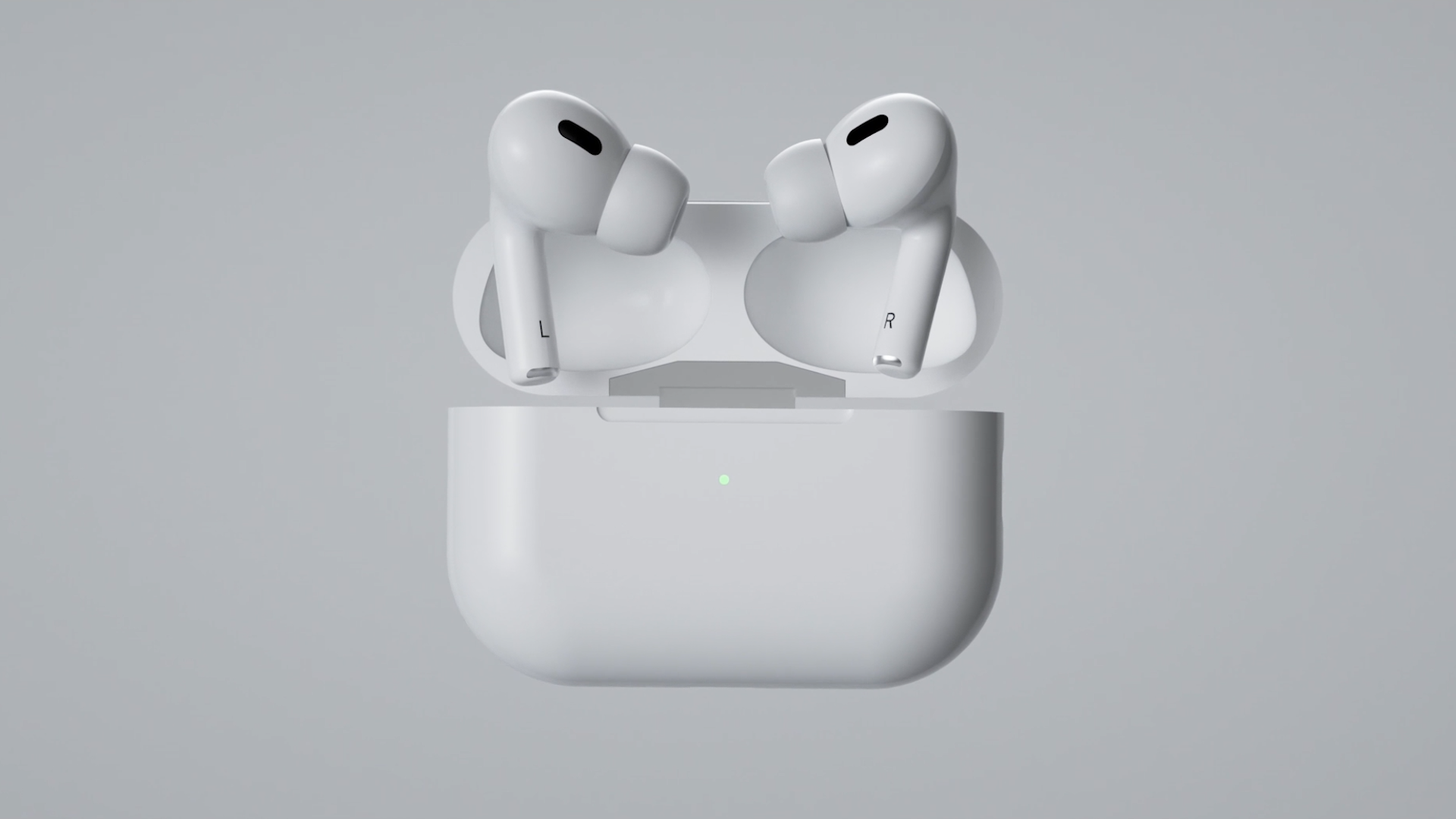 White wireless earbuds resting in an open charging case with a sleek design, featuring a small LED indicator light, against a light grey background.