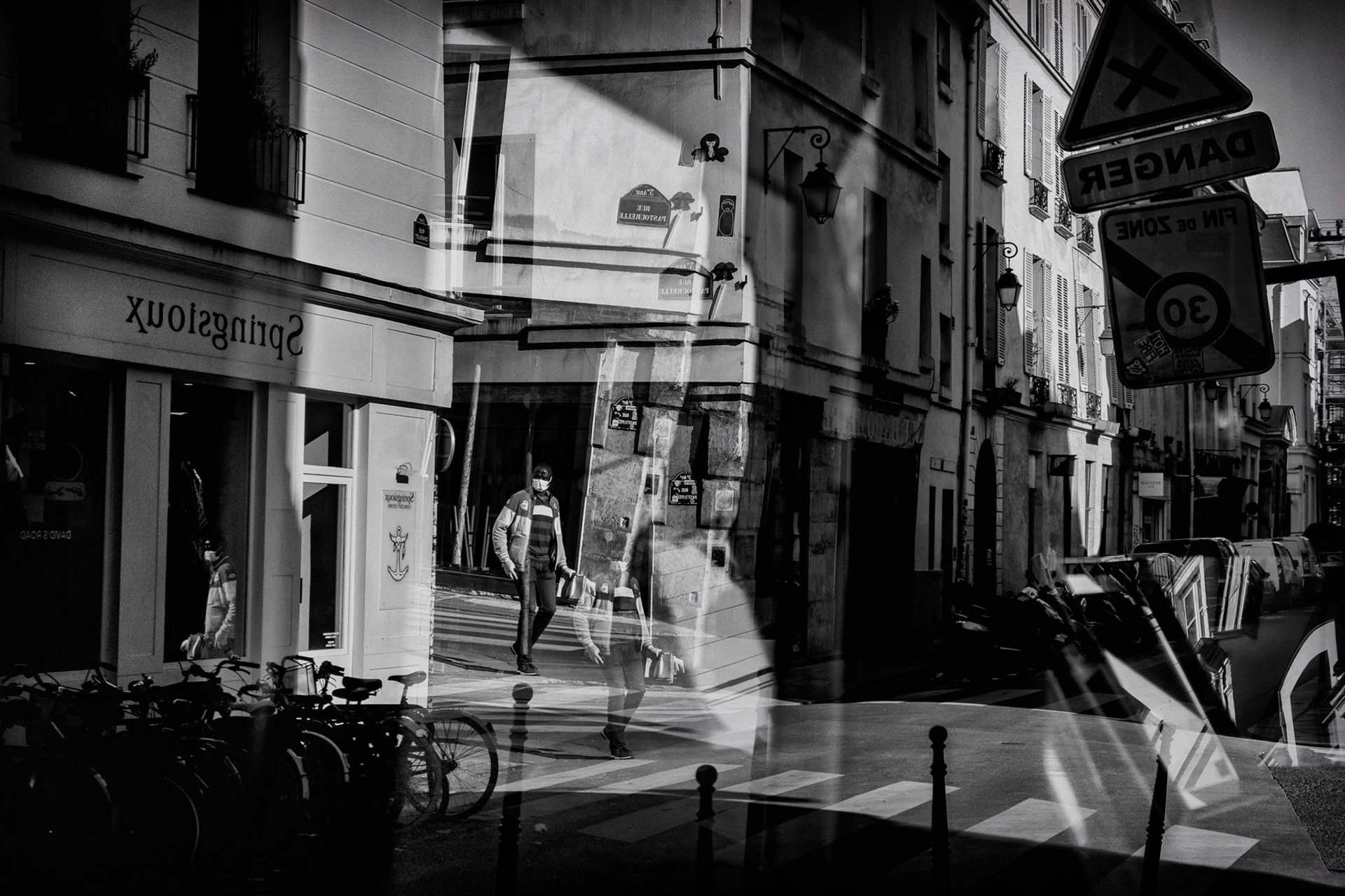 22 avril 2020. Pendant le confinement certains que l'on surnomme "2ème ligne" continuent leur travail. ici un laveur de carreaux dans le reflet d’une vitrine de la rue Pastourelle.