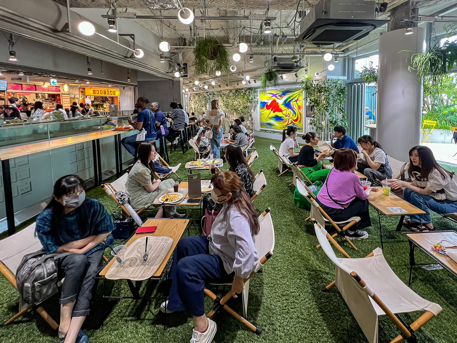 I love this indoor picnic area with fake grass. This is at a food court. 