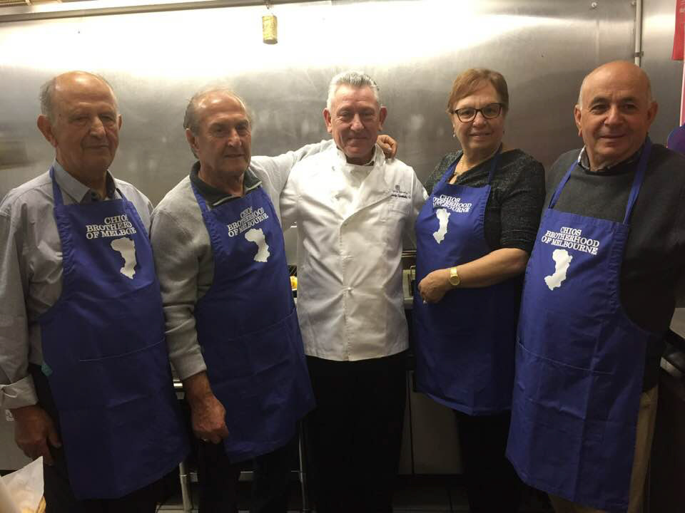 Chios Brotherhood of Melbourne's Kitchen Team Elegantly Clad in Custom-Designed Aprons Celebrating Greek Heritage