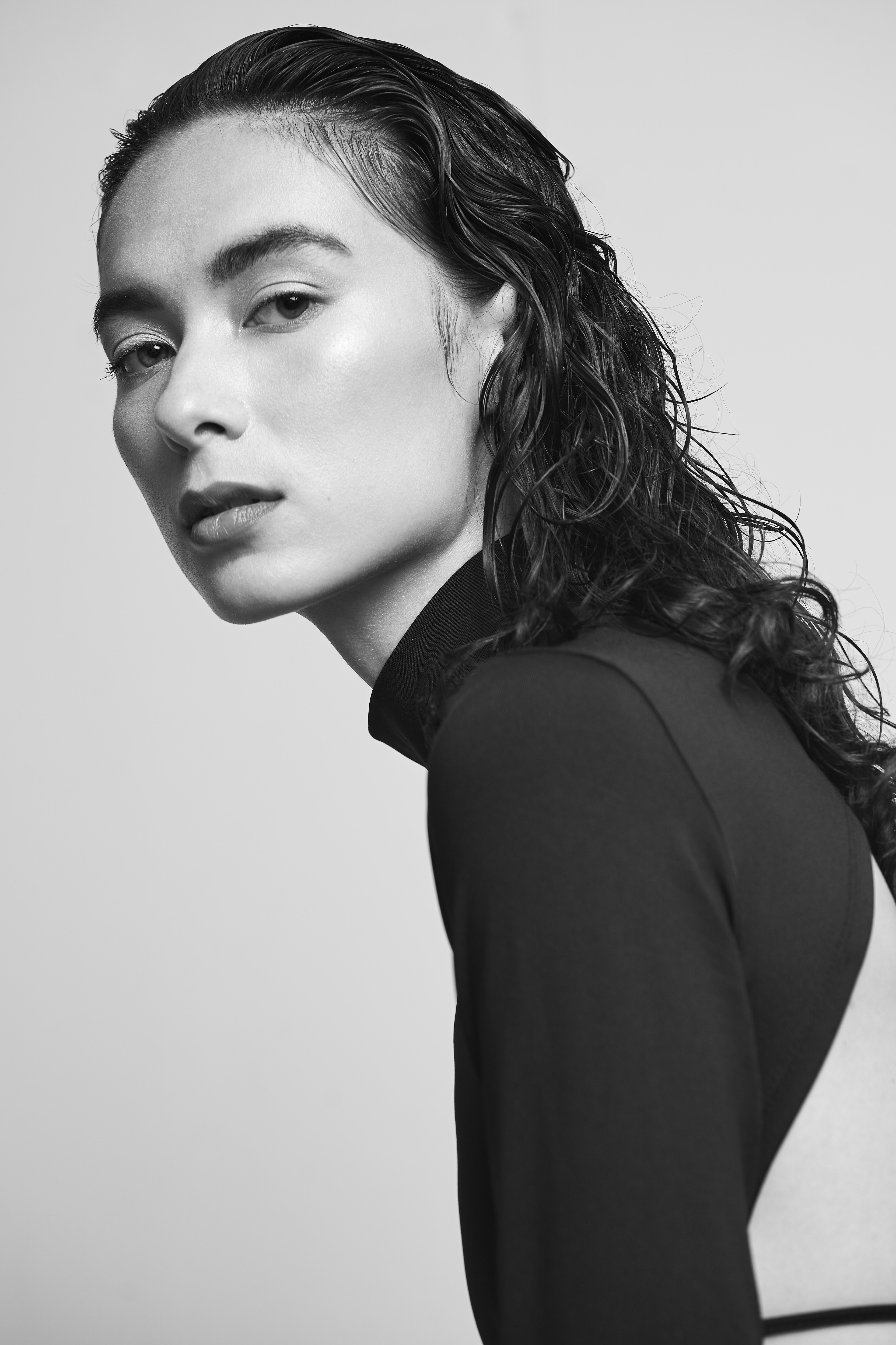 Fashion Model Suzannah Yumi shot with JMstudio in Amsterdam, in a Sleek Black Dress with slicked hair and glamourous makeup.