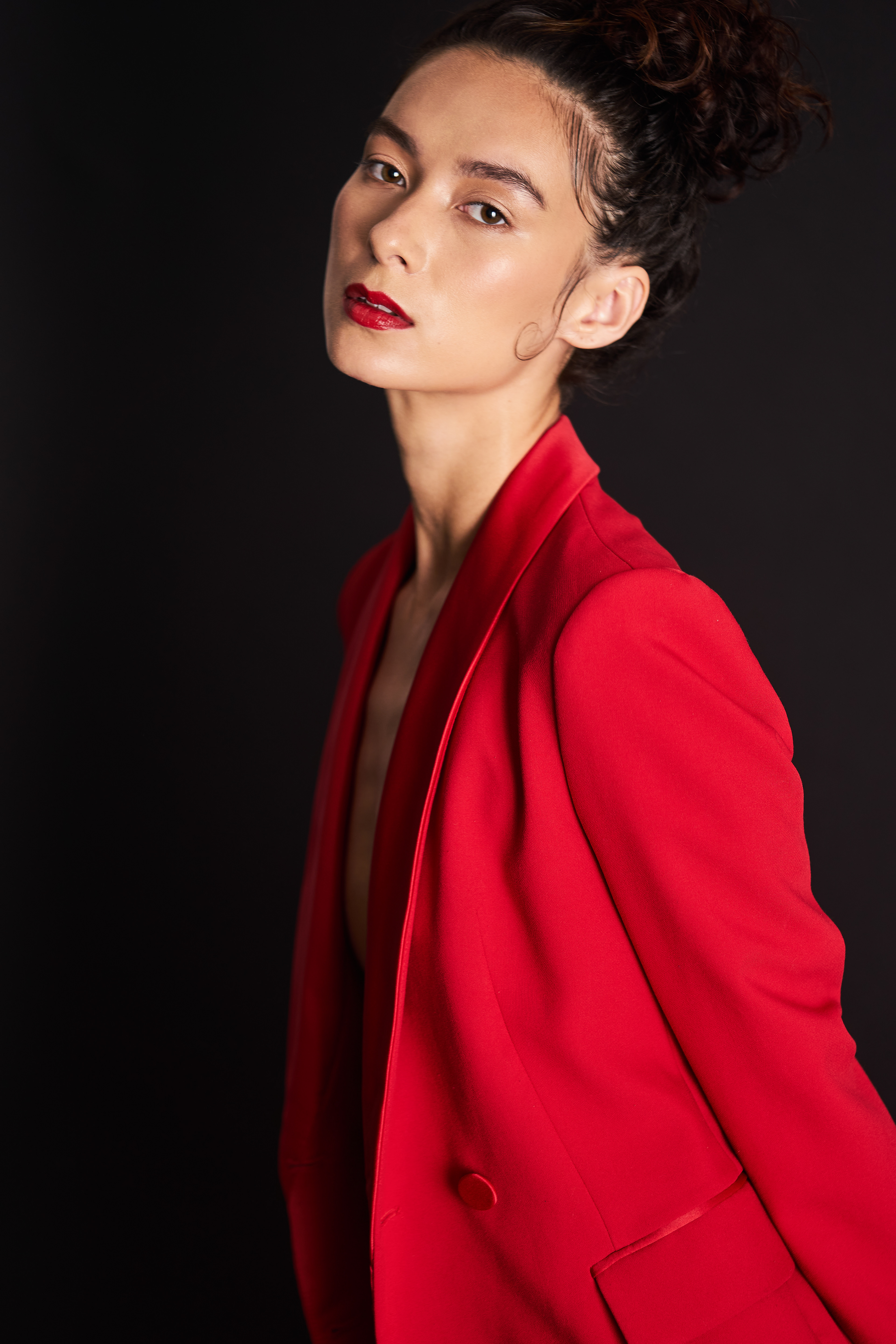 Fashion Model Suzannah Yumi shot with JMstudio in Amsterdam, sporting an up-do, a red suit, and red lips. 