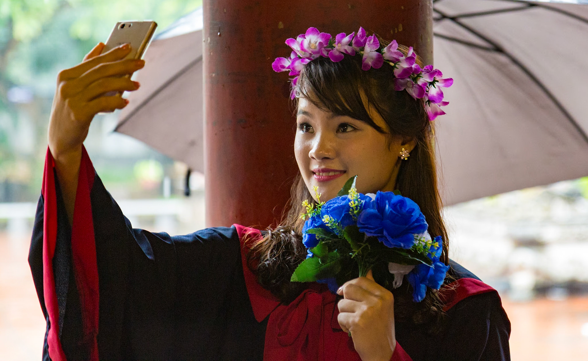 A young woman takes a "selfie" during her graduation day preparations in Hanoi