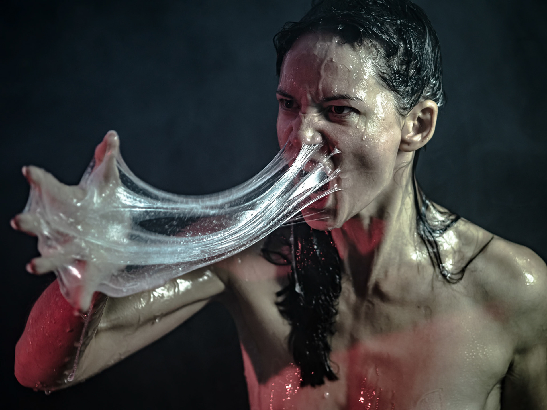 The process began by discussing emotional burdens. The model pressed the slime against her face, embodying the resistance to face inner struggles. She expressed frustration as if the slime represented external judgment. The photographer asked, "What are you refusing to see about yourself?" The model looked at the camera.