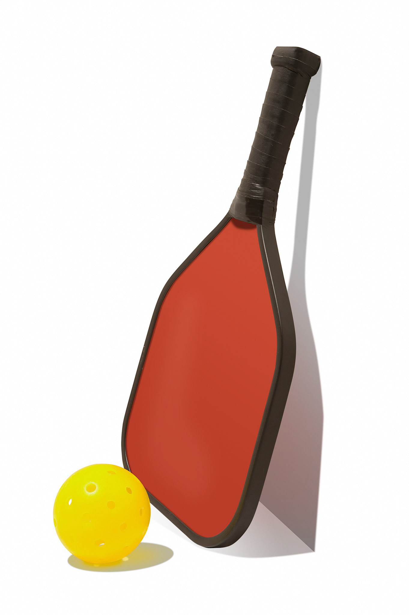 Pickleball with Paddle Leaning Against Wall       