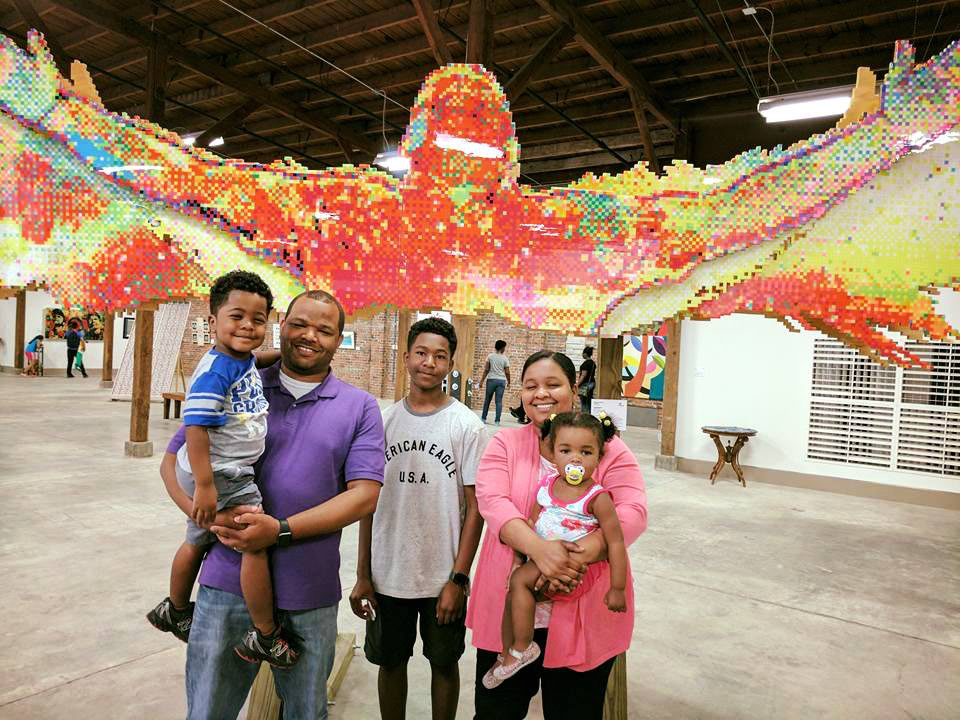 TRiUMPHANT - There are times in life when you have to be real. When holding back won’t cut it. I poured my heart into the creation of this artwork which shows my victory through pain. Never let circumstances control you. Be TRiUMPHANT.  About The Artwork:  TRiUMPHANT was created over the course of 7 months and has over 18,000 hand punched and individually glued squares of various colored card stock paper to form one image. It was nearly 15 1/2 ft long and stands around 9ft tall. 