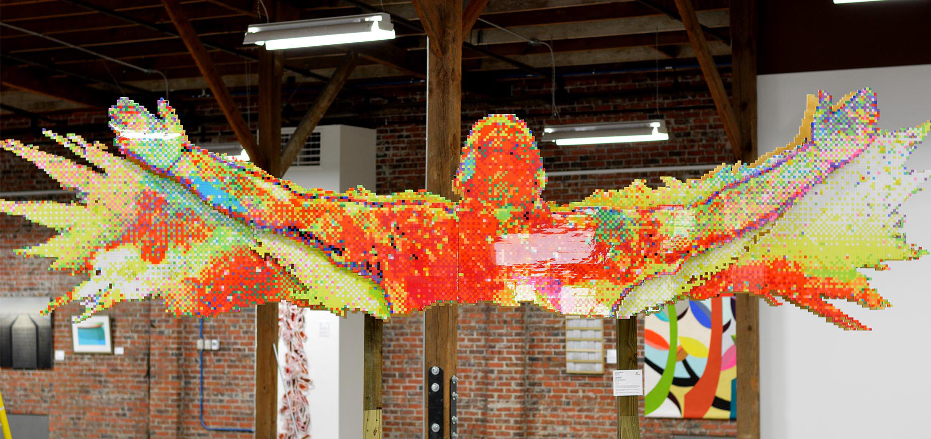 TRiUMPHANT - There are times in life when you have to be real. When holding back won’t cut it. I poured my heart into the creation of this artwork which shows my victory through pain. Never let circumstances control you. Be TRiUMPHANT.  About The Artwork:  TRiUMPHANT was created over the course of 7 months and has over 18,000 hand punched and individually glued squares of various colored card stock paper to form one image. It was nearly 15 1/2 ft long and stands around 9ft tall. 