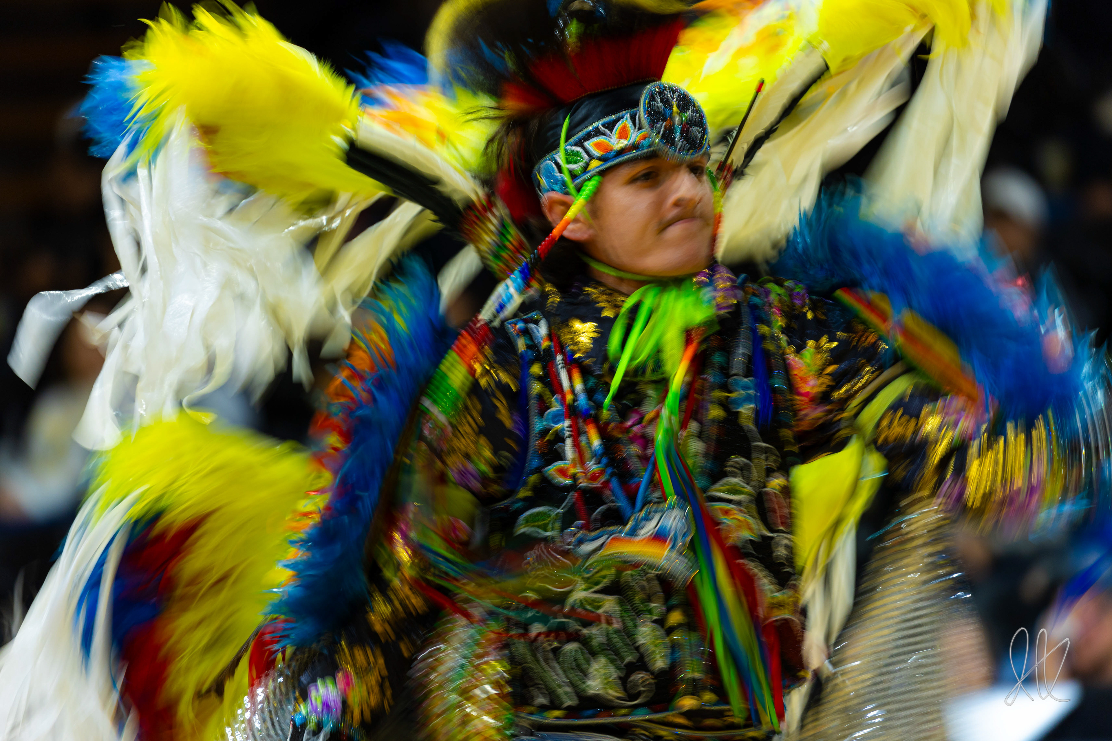 A member of a tribe shows off the outfits and dances of his tribe during a halftime show