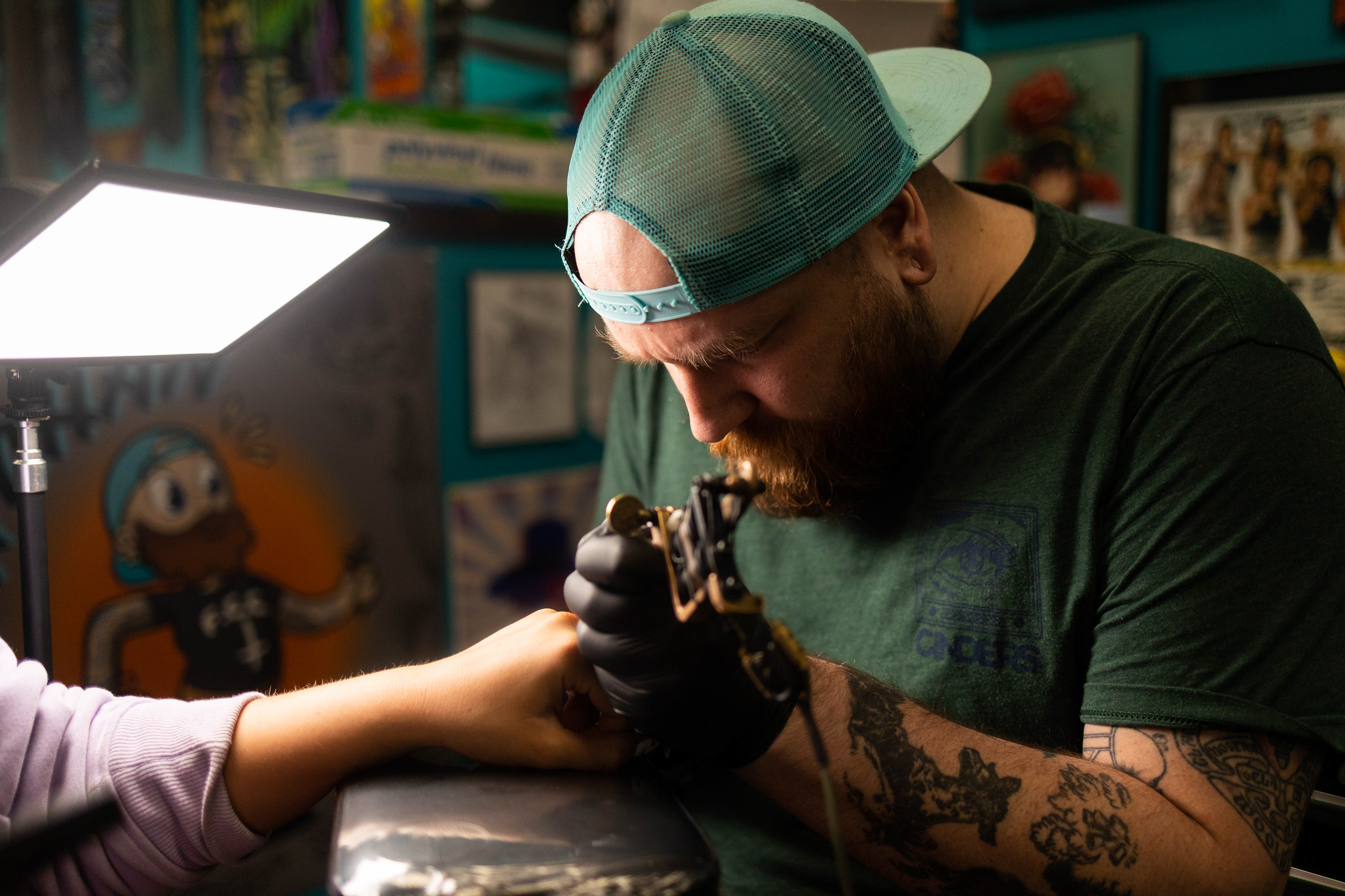 Brad Sheets diligently touches up a client's finger tattoo at Moscow Tattoo Company. Moscow Tattoo Company won the Argonaut’s Best of Moscow: Tattoo Parlor for 2023. March 30, 2023. (Argonaut/John Keegan)