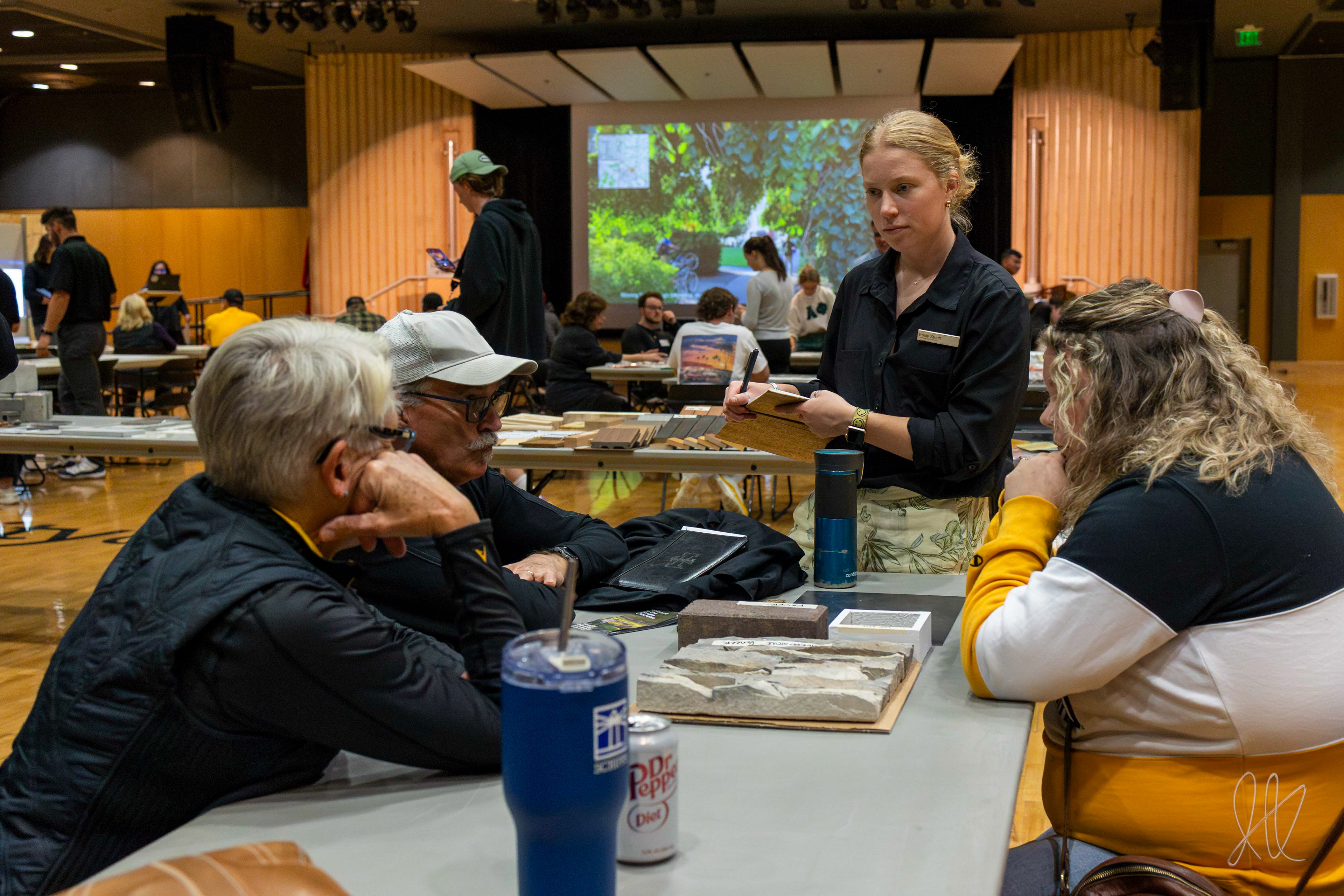 Emily Stuart consults with attendants of the Healing Garden Design Charrette, to learn how to best honor lost UI students