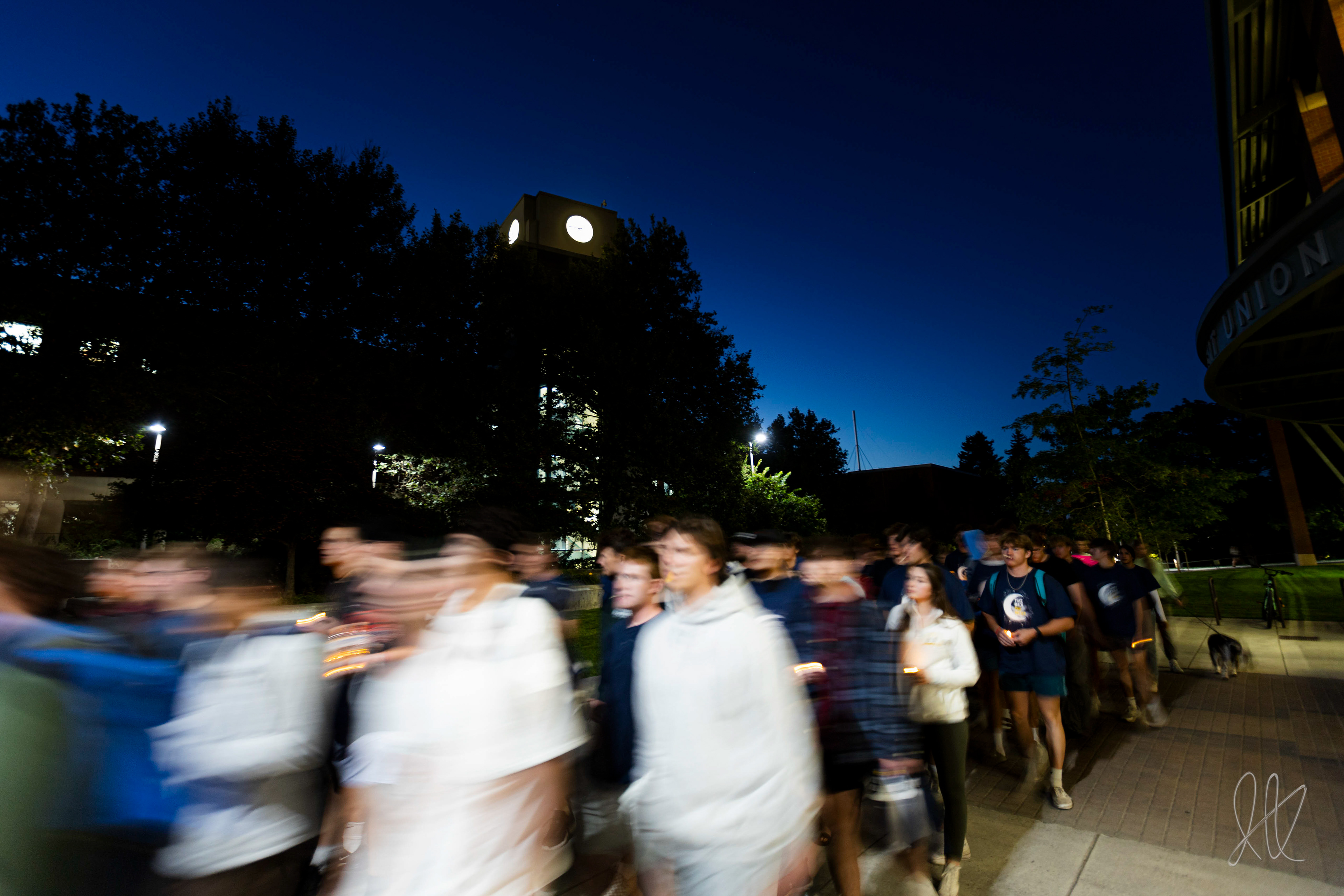 Students march under the University of Idaho Library Clocktower during the "Take Back the Night" march