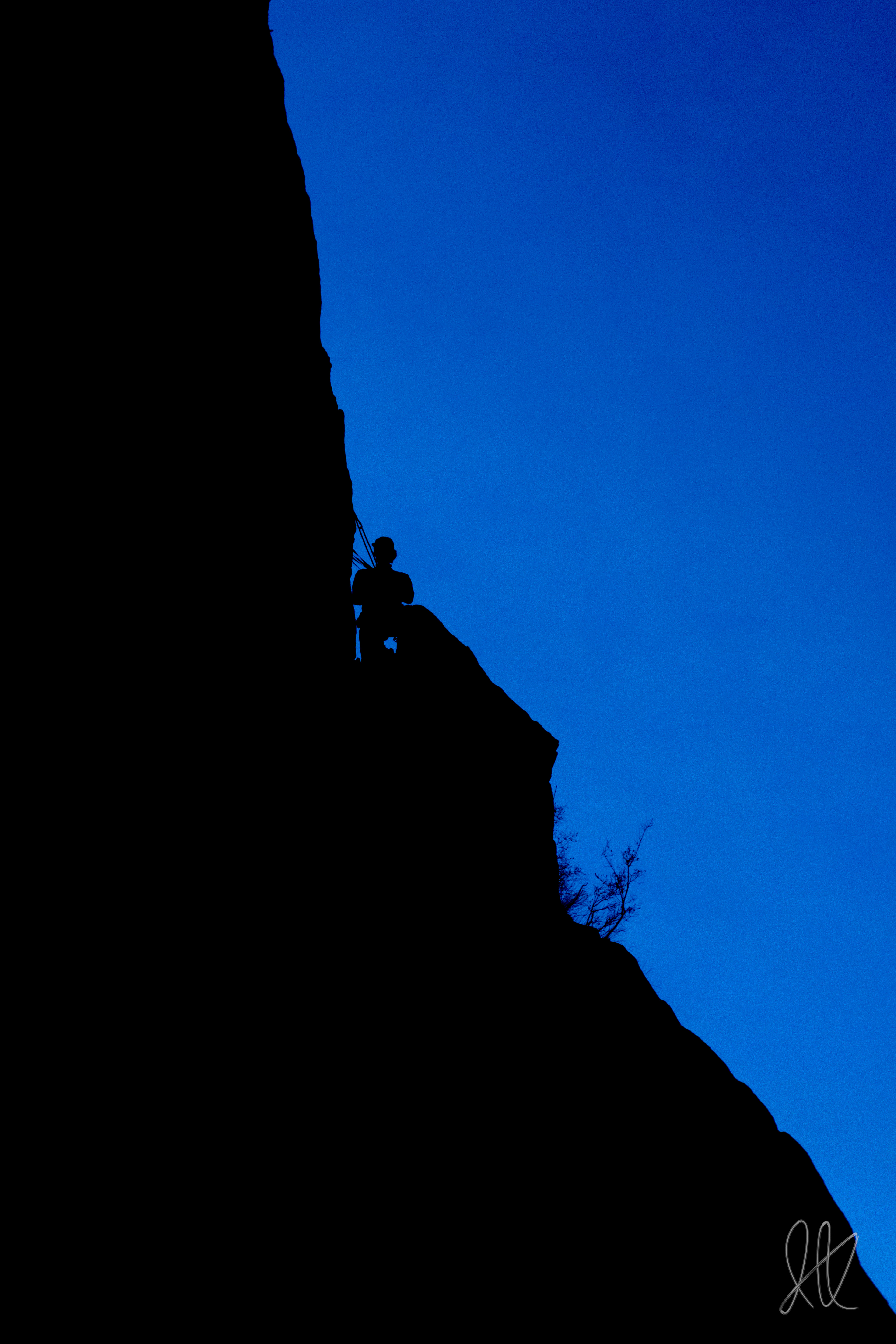 Ian Kolaja stands silhouetted against the evening sky