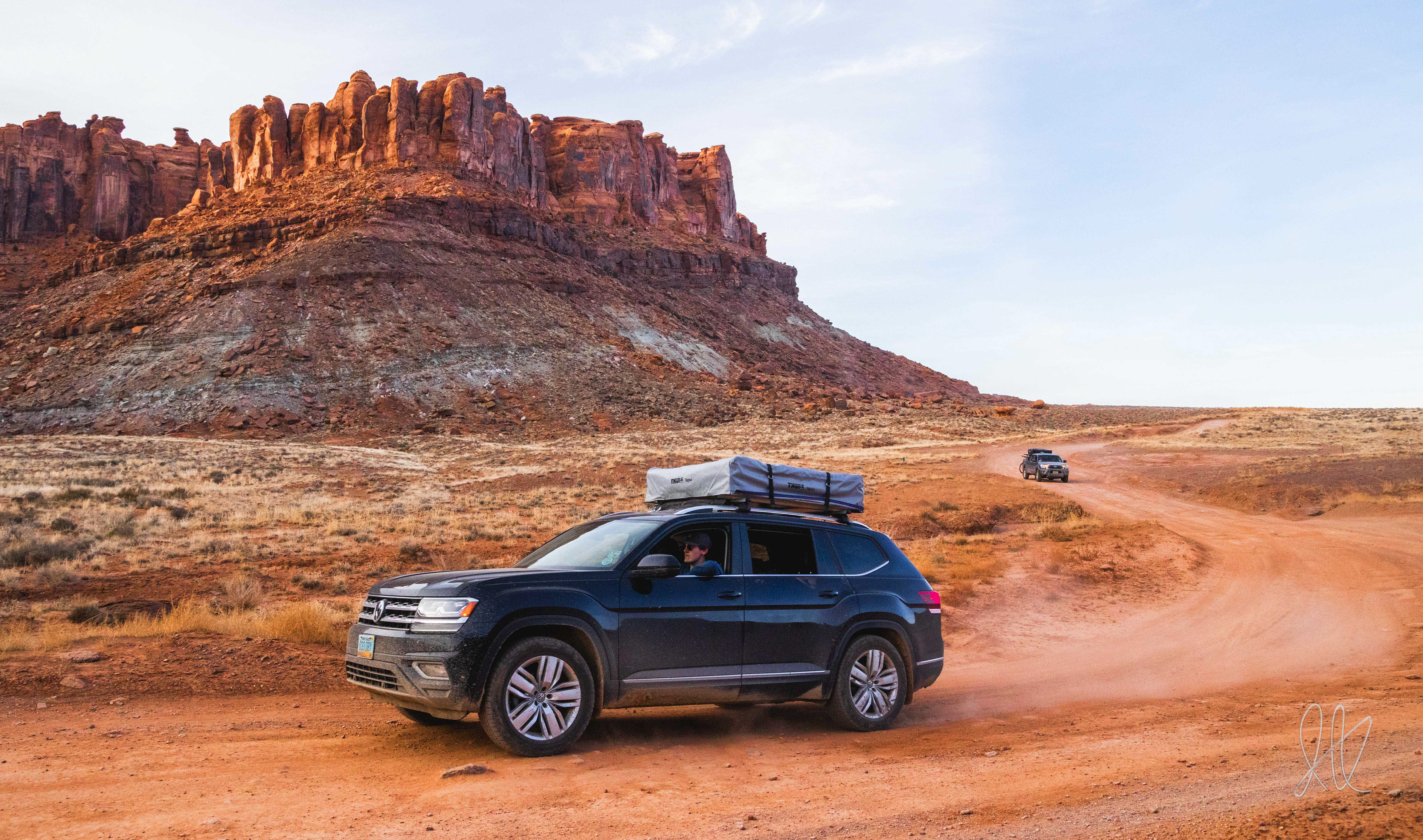 Gavin Aus and Ian Kolaja drive down Gemini Bridges road in near Moab, Utah