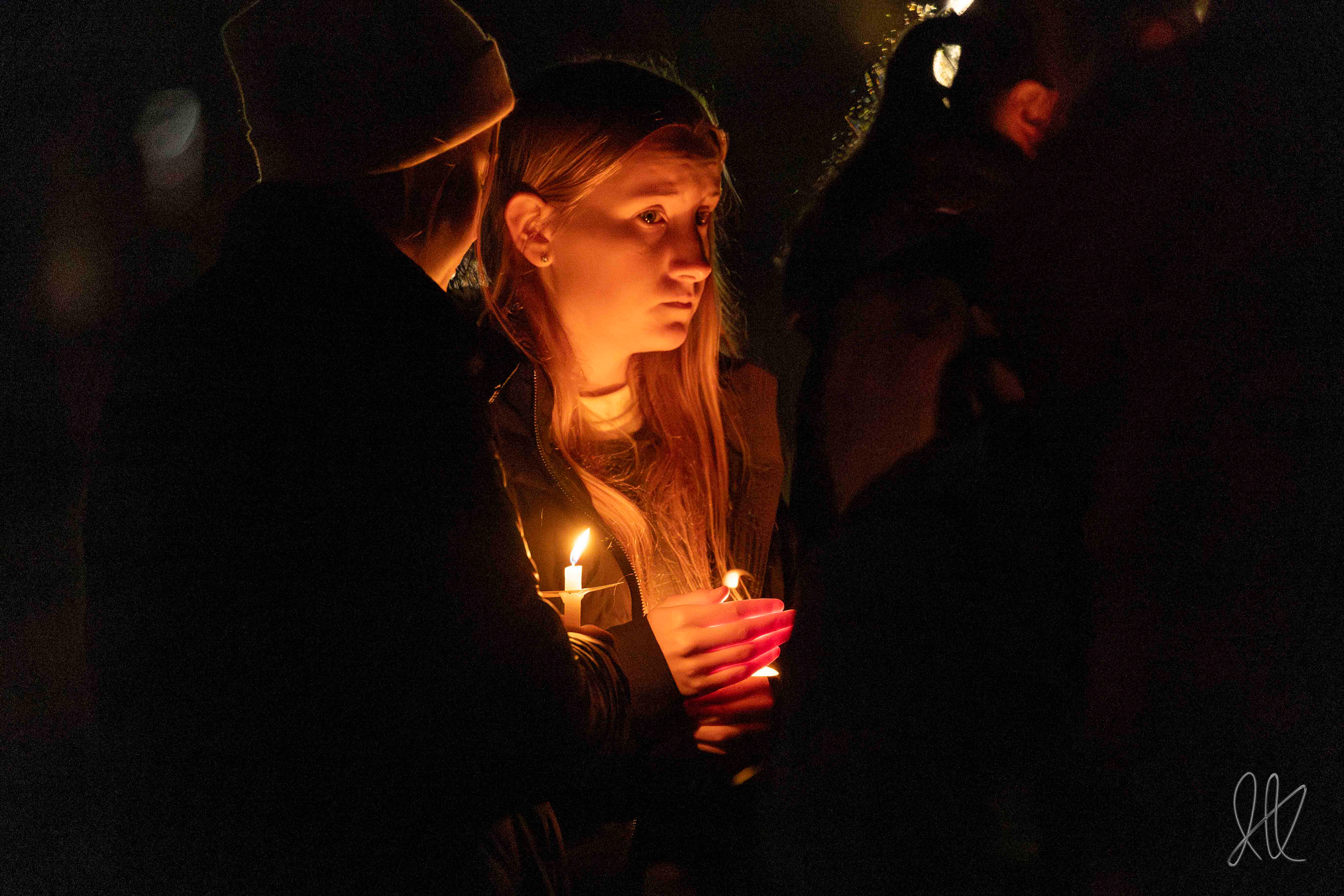 Attendees mourn at the candlelight vigil marking the one year anniversary of the UI Murders