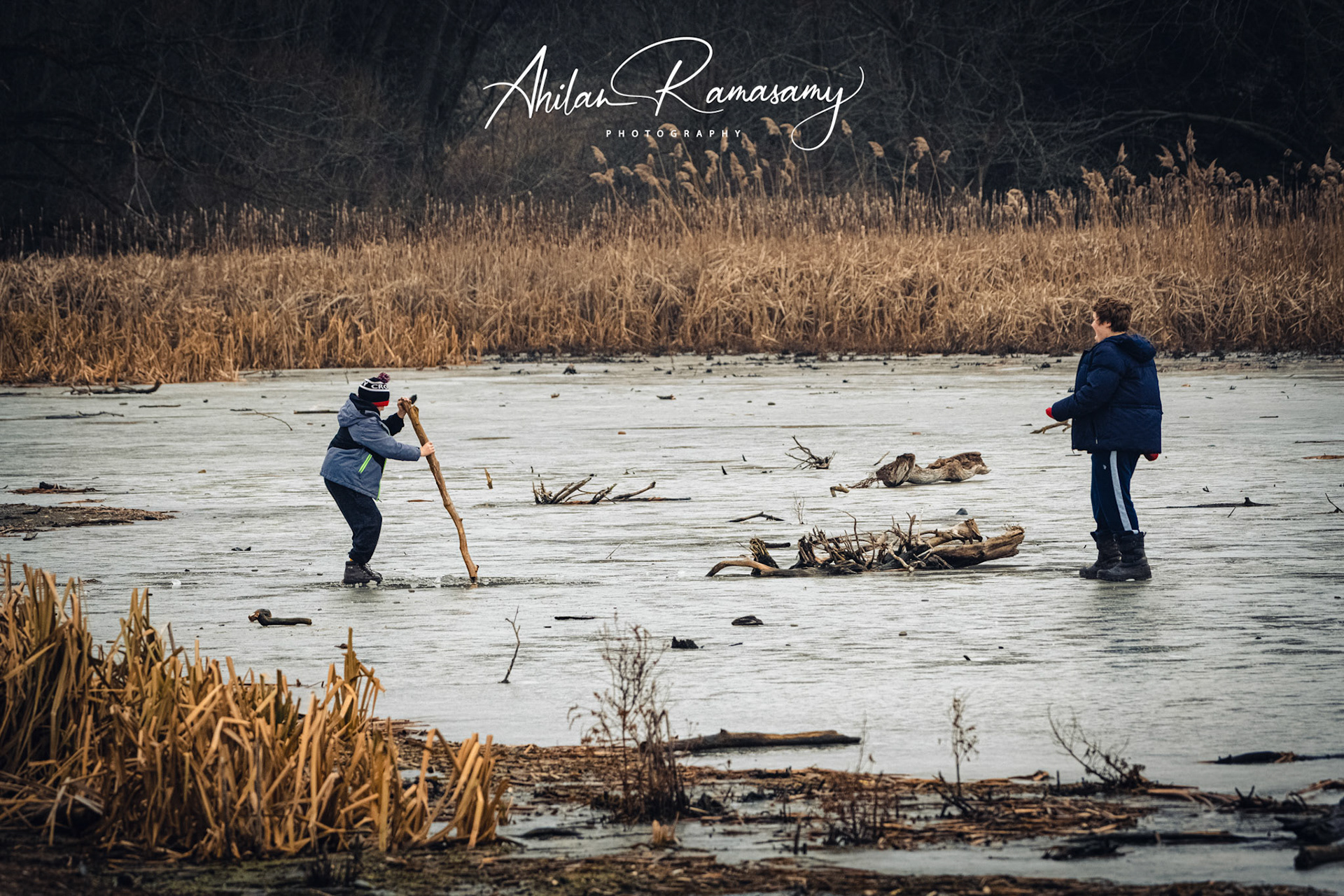 Kids having fun over a frozen marsh