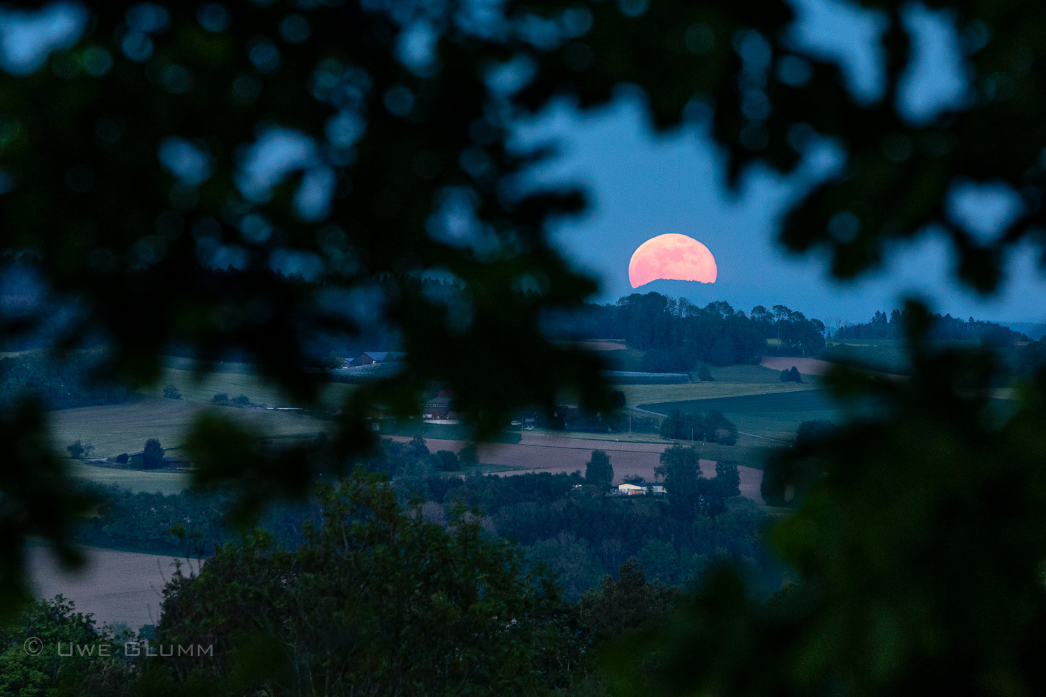 Rising of the moon behind the foothills of the alps. Hoechsten, Germany. 2020.
