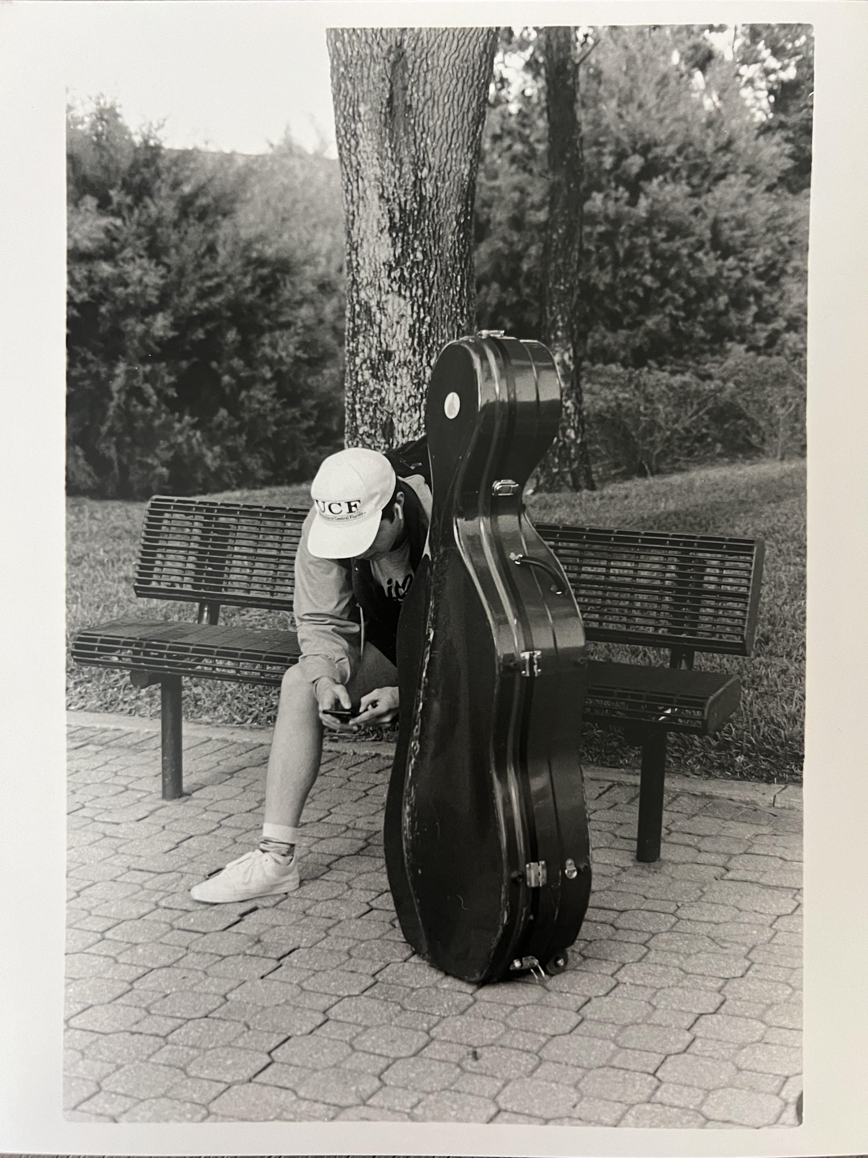 A cello player on his phone