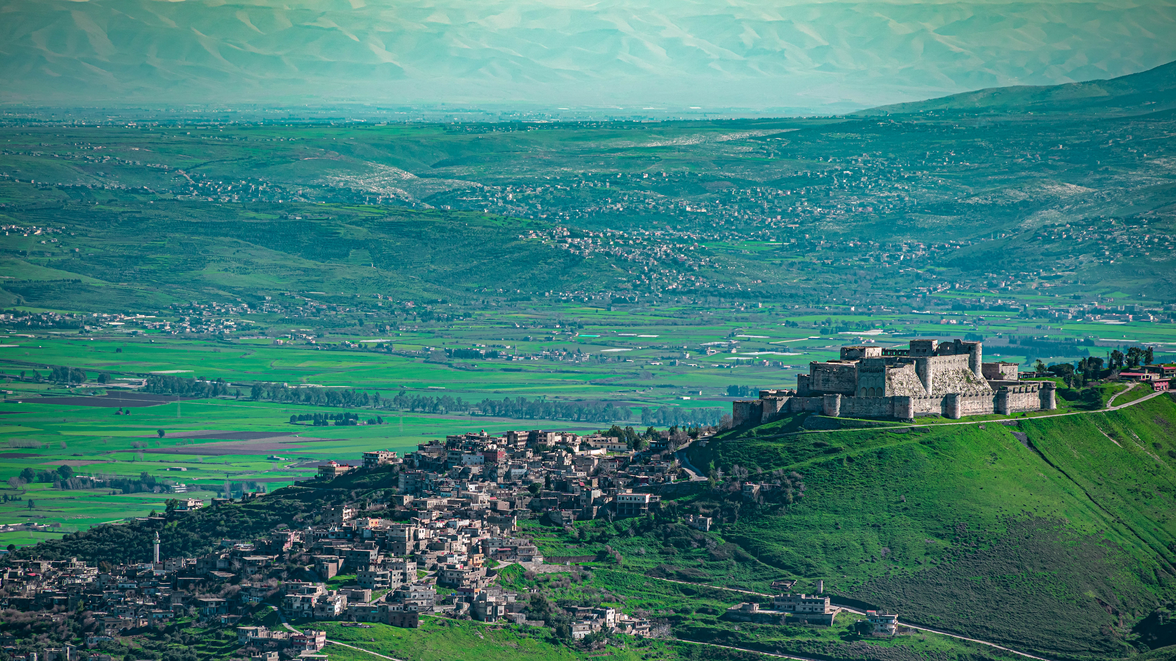 Verdant Majesty: A Castle's Regal View Amidst a Sea of Greenery Overlooking the City