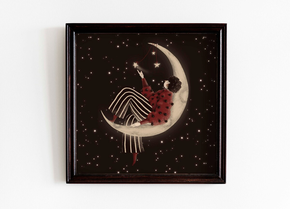 Framed fantasy art print featuring a whimsical illustration of a woman sitting on a crescent moon, wearing a red polka-dotted sweater and striped pants, reaching for glowing stars against a dark starry background - illustrations by Darka White