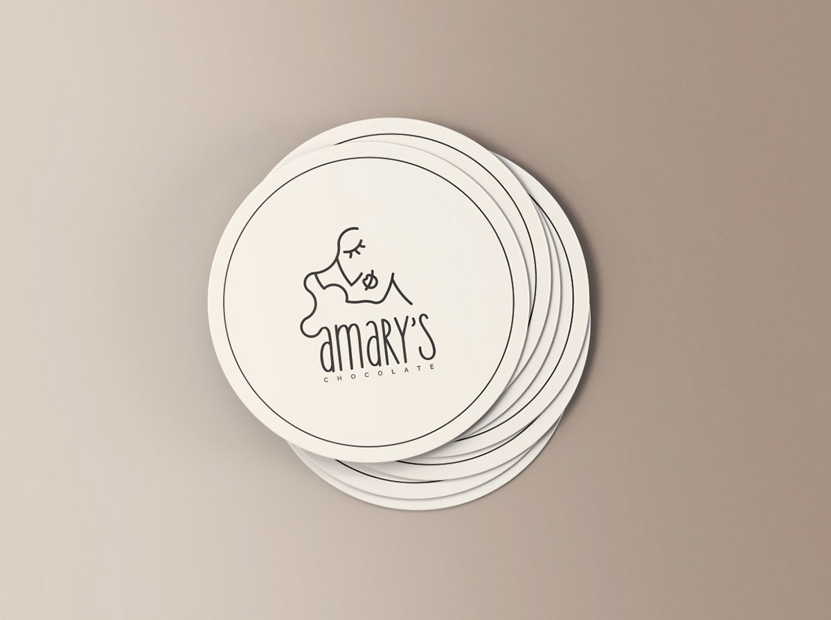Logo design for Amary's Chocolate by graphic designer Darka White, displayed on round labels, featuring a feminine illustration and elegant typography, reflecting the brand's sophisticated and elegant identity.