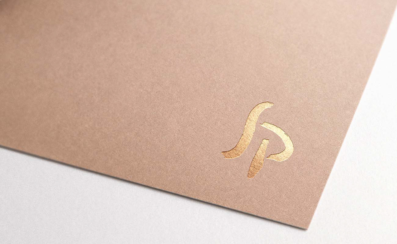 Studio Psacaropulo logo designed by graphic designer Darka White, printed on high-quality paper with golden letters, showcasing elegant typography to reflect the artistic heritage of the association.