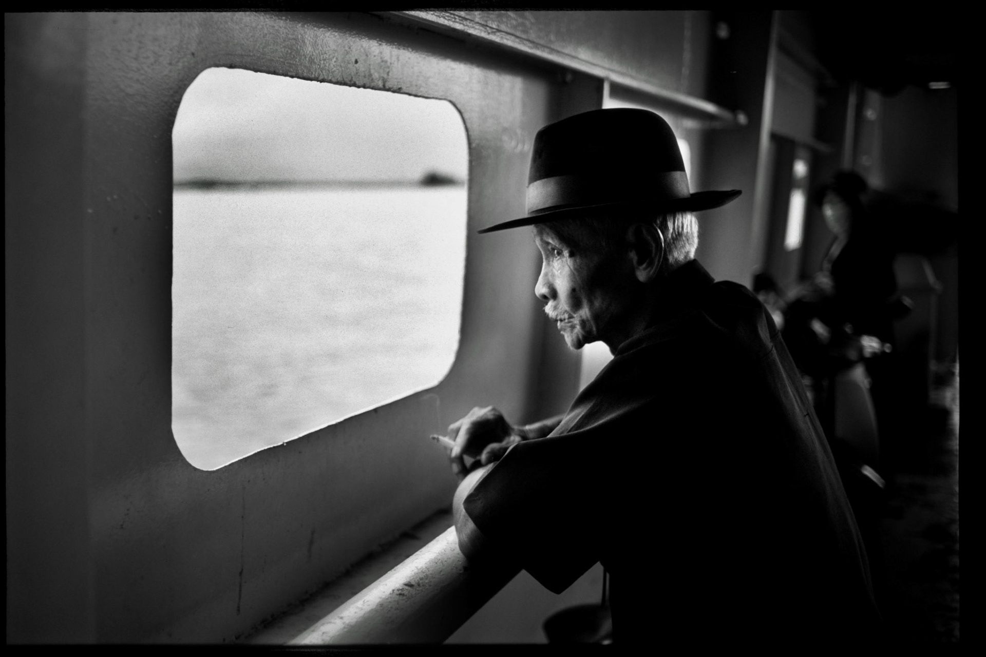 a old vietnamese is looking the mekong river during evening time. it was war here in vietnam exactly 30 years ago. USA invaded vietnam and killed so many innocence people in vietnam.....