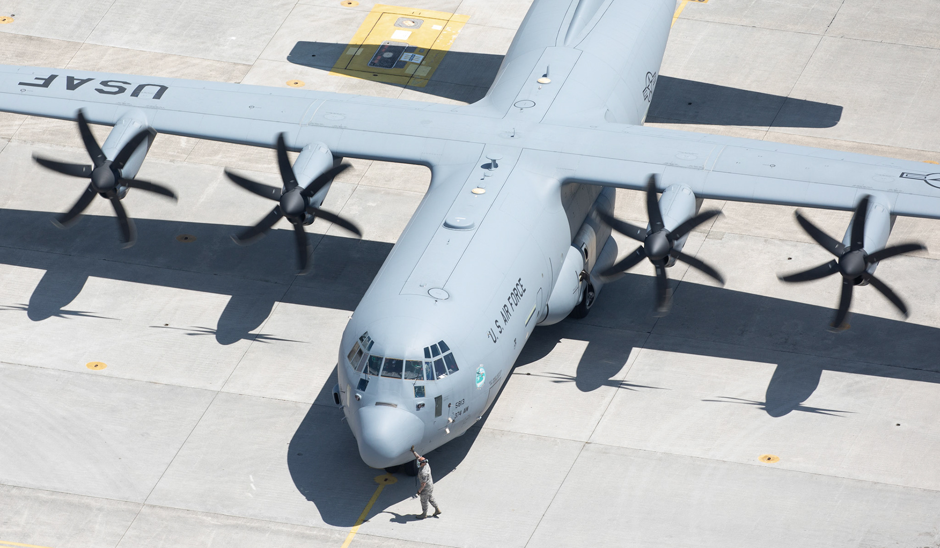 A crew chief from the 374th Aircraft Maintenance Squadron inspects a C-130J Super Hercules' nose before it taxis to the runway during the 374th Airlift Wing (AW) Generation Exercise Elephant Walk at Yokota Air Base, Japan, May 4, 2018. The 374th AW conducted the exercise to train the wing’s ability to rapidly provide humanitarian aid and disaster relief throughout the Indo-Pacific region. (U.S. Air Force photo by Yasuo Osakabe)