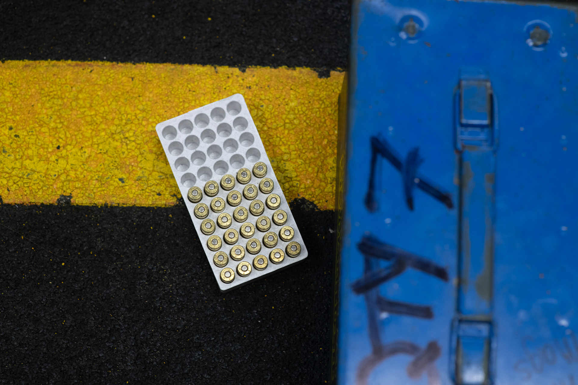 M9 Beretta pistol 9 mm rounds sit next to an ammunition box during an Excellent-In-Competition at Yokota Air Base, Japan, April 12, 2022. The four-day competition was held to boost morale and test 165 active-duty military members on how accurate they can shoot their authorized duty pistols. The top 10% scorers will earn the Air Force Excellence In Competition medal to wear on the Service Dress Uniform. (U.S. Air Force photo by Yasuo Osakabe)