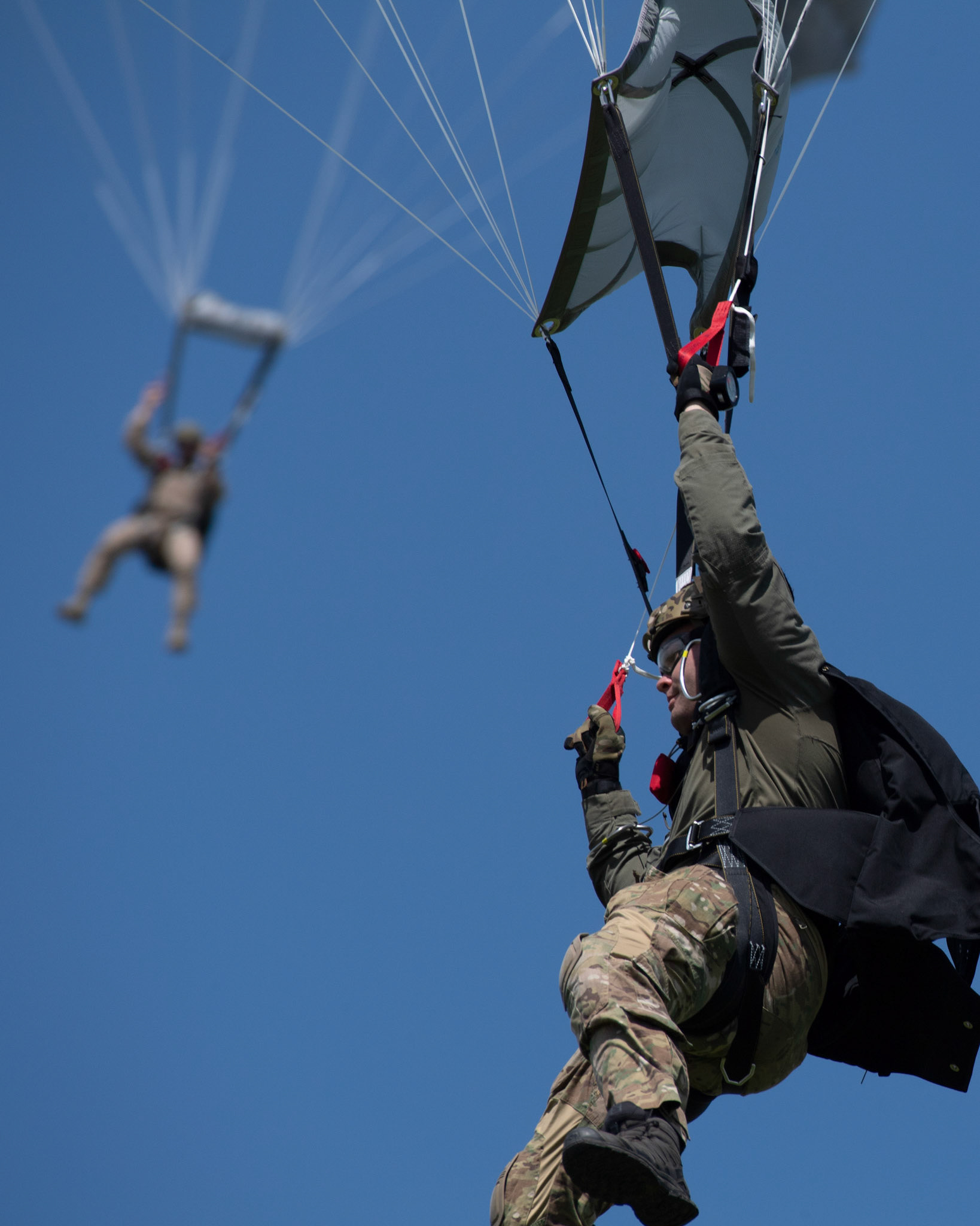 U.S. Navy SEALs (Sea, Air and Land) Team One parachute from a U.S. Air Force C-130J Super Hercules over Yokota Air Base, Japan, June 17, 2020, during Exercise Gryphon Jet. Gryphon Jet is an integrated training exercise focused on improving interoperability throughout the special operations community. (U.S. Air Force photo by Yasuo Osakabe)