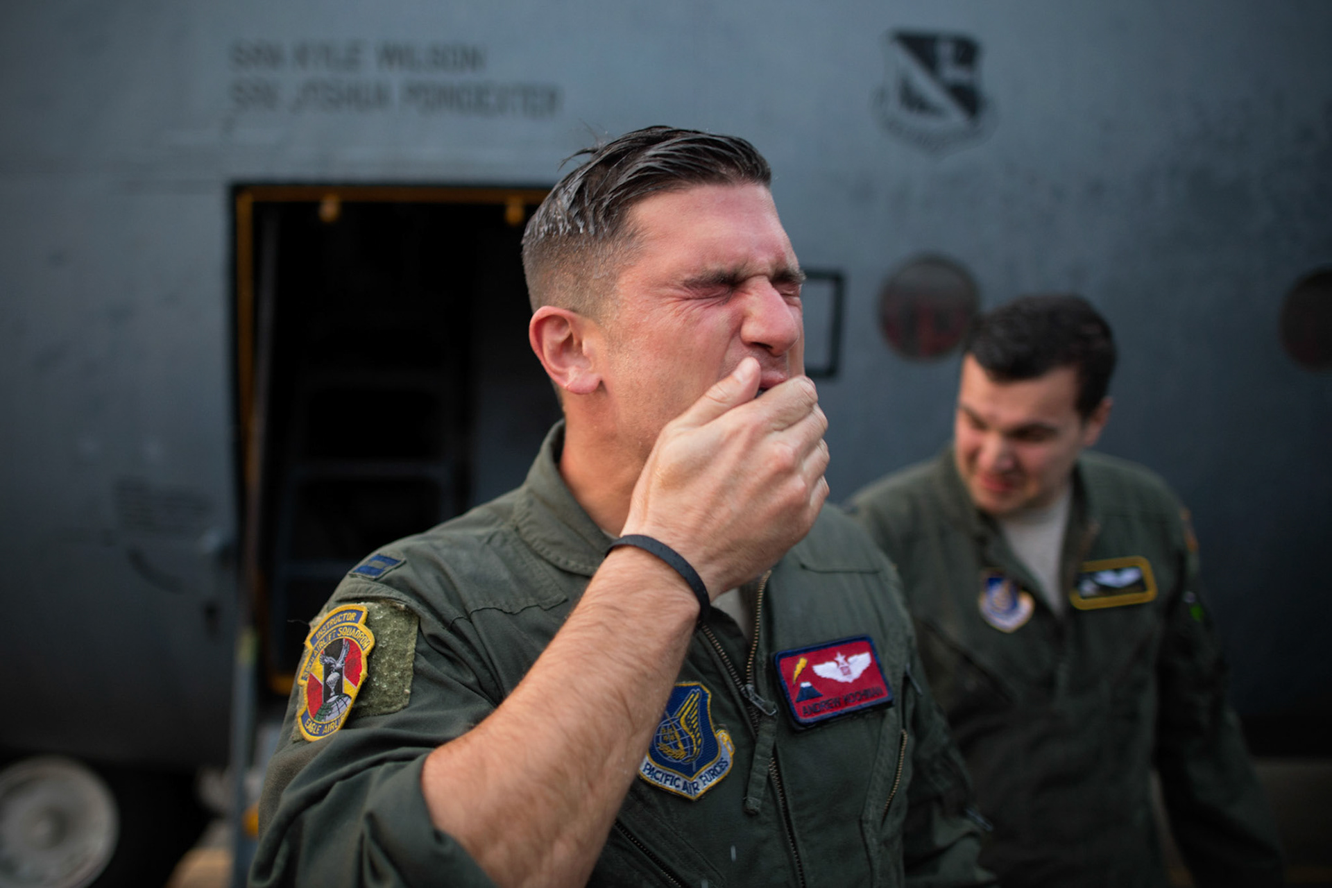 Capt. Andrew Kochman, 36th Airlift Squadron navigator, wipes his face after getting sprayed with water after completing the last active-duty C-130H tactical training sortie at Yokota Air Base, Japan, Oct. 5, 2017. "It's the fulfillment of a childhood dream, and it'll always hold a special place in my heart that most actual people will never occupy," said Kochman when asked what the H-model means to him. (U.S. Air Force photo by Yasuo Osakabe)