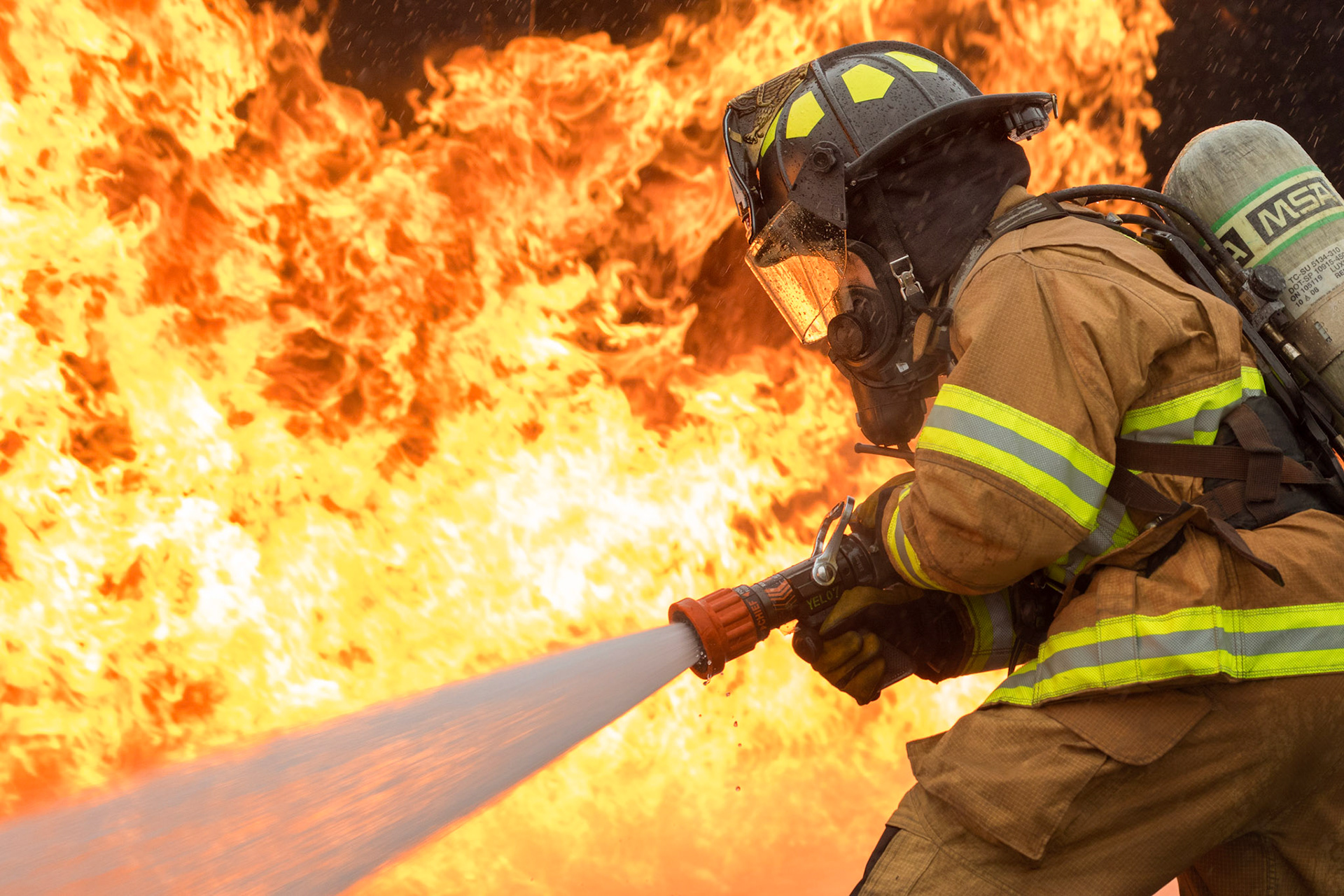 Senior Airman Eric Poole, 374th Civil Engineer Squadron firefighter, battles a simulated aircraft fire during live-fire training at Yokota Air Base, Japan, March 8, 2018. Aircraft live-fire training is conducted periodically throughout the year to ensure Airmen and civilians with the 374th CES and 374th Maintenance Squadron repair and reclamation section are always prepared to combat aircraft fuel fires. (U.S. Air Force photo by Yasuo Osakabe)